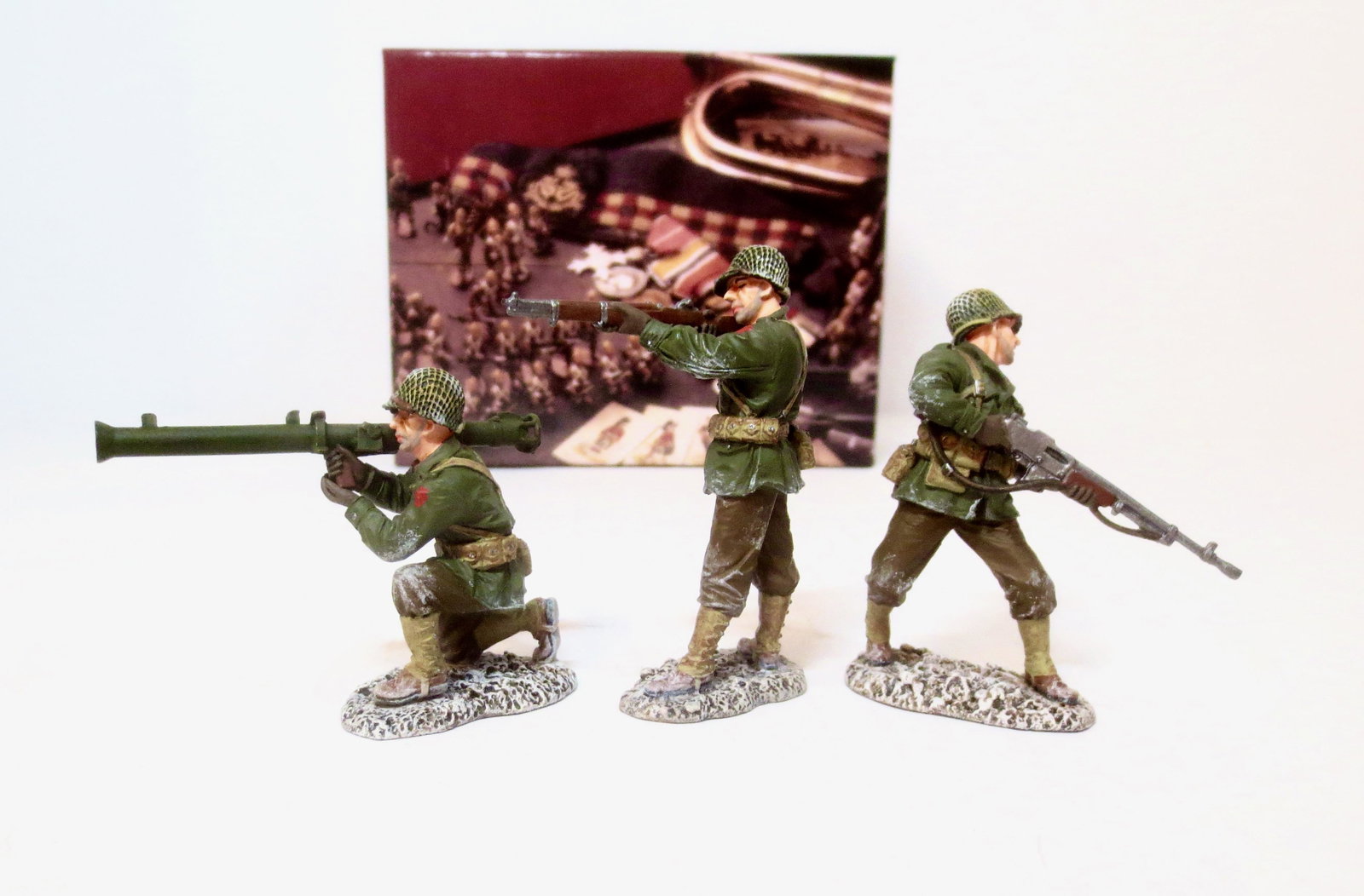 King & Country #BBA090 "Winter Bazooka Team": U.S. ‘Bazooka’ GI protected by two of his buddies, one carrying the B.A.R., the M1918 Browning Automatic Rifle the squad support weapon throughout WW2 and beyond, and the other GI is aiming his al