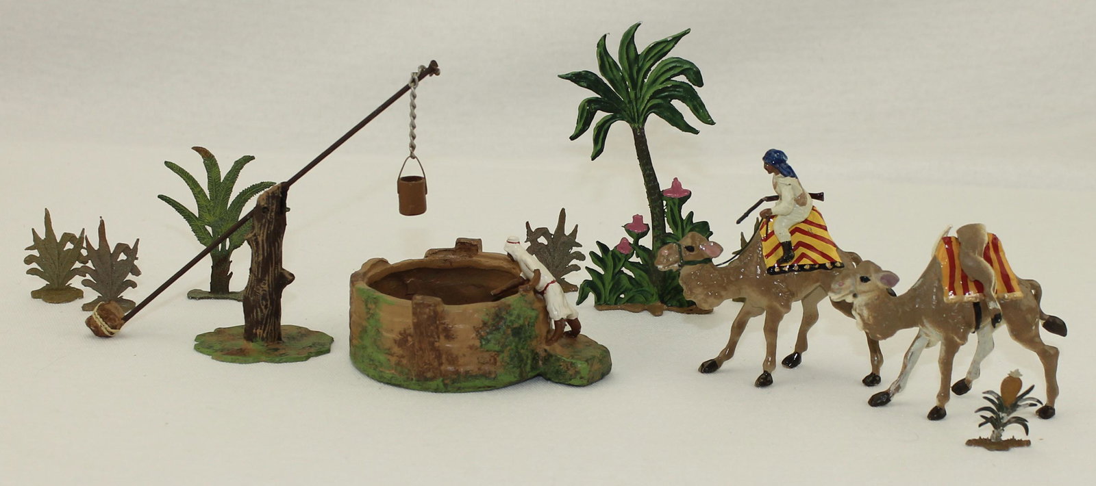 Potsdamer Zinnfiguren Arab Hunters Camels: Arab Hunters with Camels. Lot includes Arab Hunters with Camels and Dead Gazelle, Well, Water Buckets and an Assortment of Trees. 11 Pieces. Condition Very Good to Excellent. No Box.