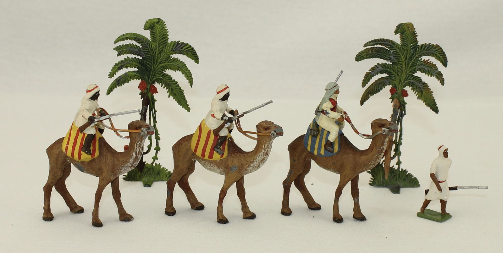 Heyde of Germany Lot Arab Caravan: Arab Caravan. Circa 1930's. Lot includes 2 Camels with Riders, 1 Camel with Rare Anglo Rider, 1 Arab on Foot with Rifle and 2 Palms. 6 Pieces. Condition Very Good. No Box.