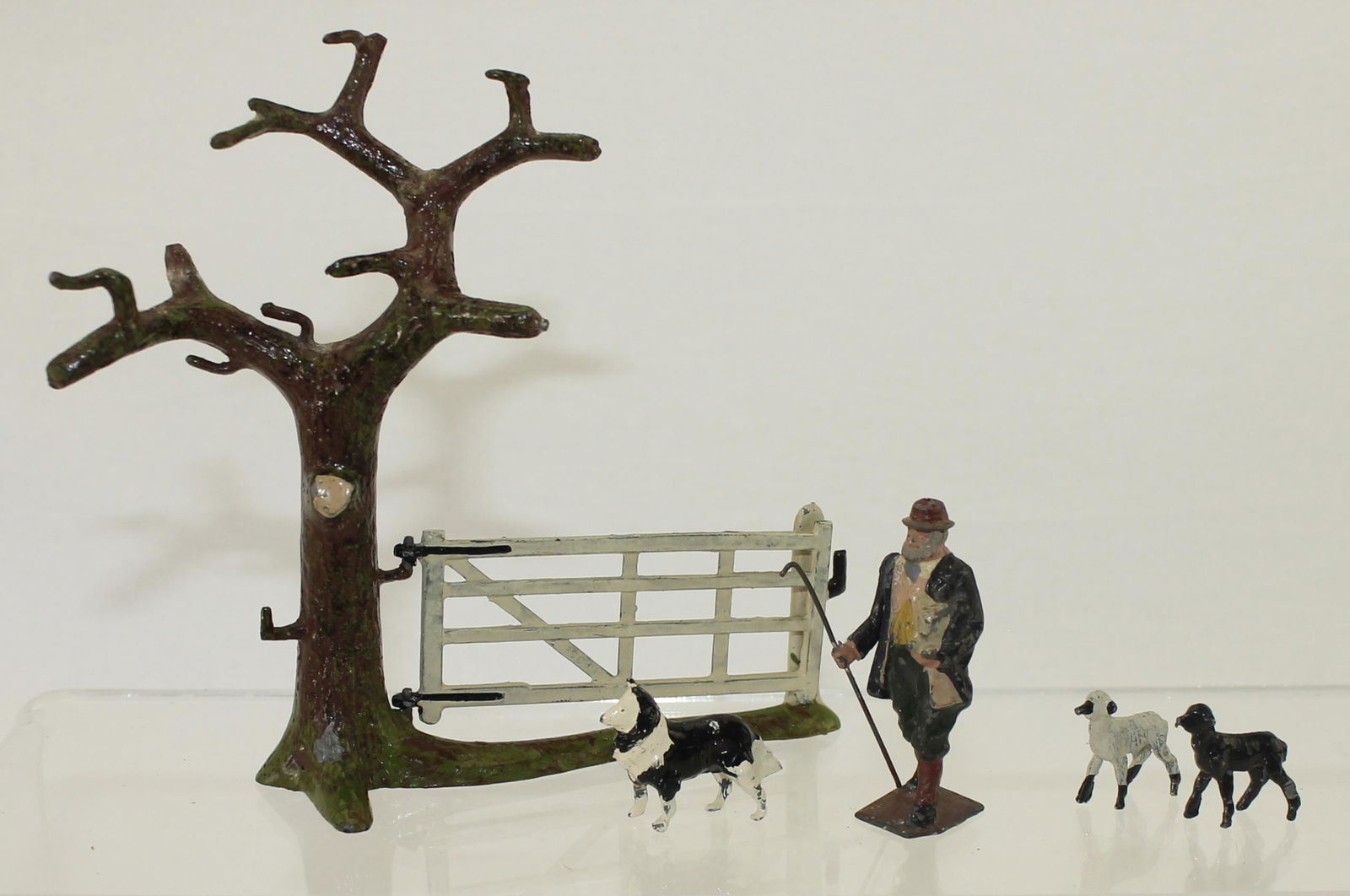 Britains Lot Shepherd with Lamb: Farm Series. Pre-War. Lot includes Set 7-E Tree with Gate, Set 594 Shepherd with Lamb.5 Pieces. Condition Very Good. No Box.