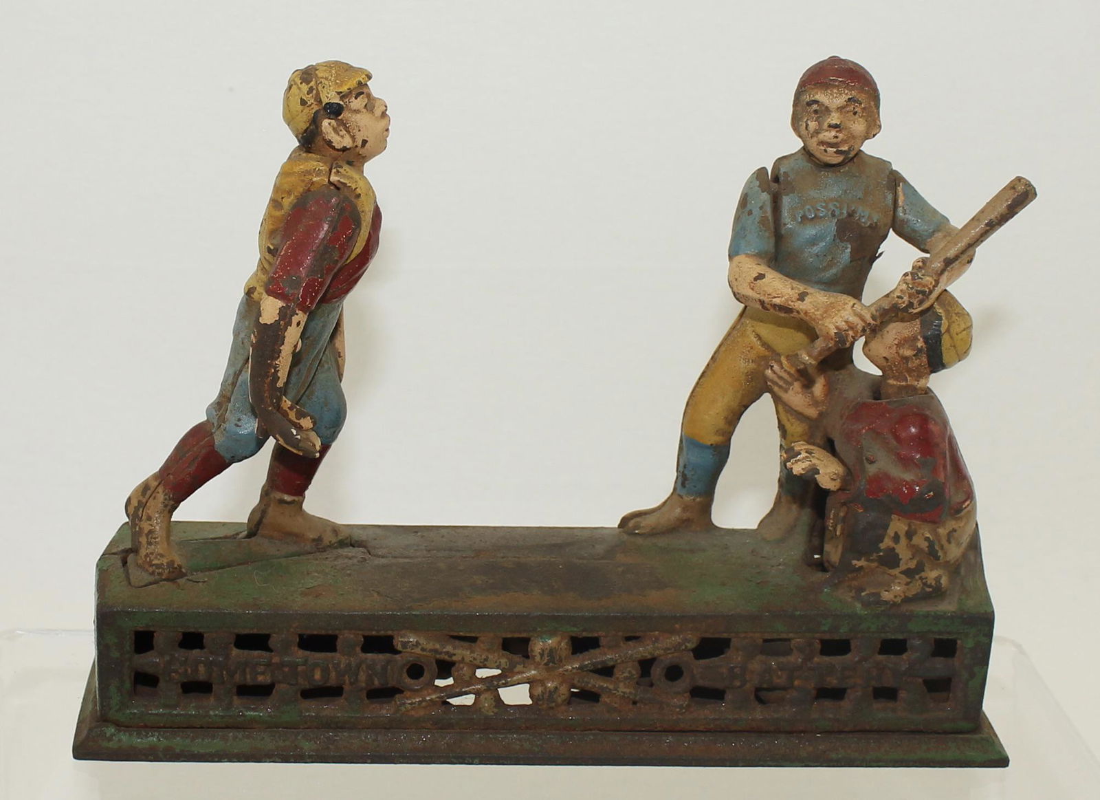 Reproduction Cast Iron Bank: Book of Knowledge Company. Coin Operated Cast Iron Bank. "Home Town Battery." Reproduction Piece. Distressed and Rusted for Effect. 1 Piece. Condition Good. No Box.