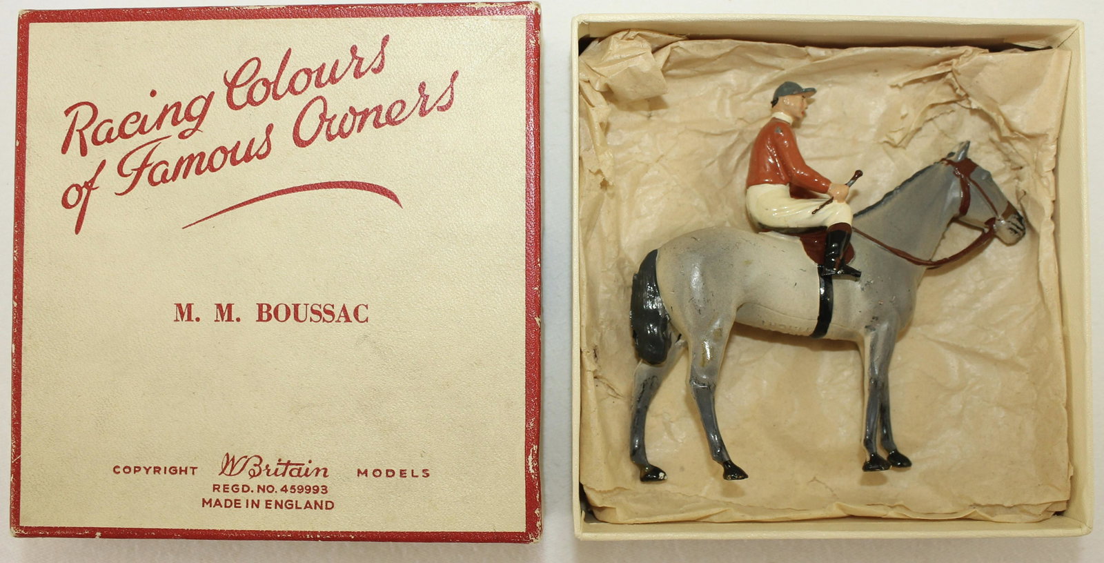 Britains French Racing Colors: Set RC-144. M. M. Boussac. (Monsieur Marcel Boussac). Post War. Rider's Crop Intact. 2 Pieces. Condition Very Good. Chips on Horse's Hind Quarter. Box Very Good.