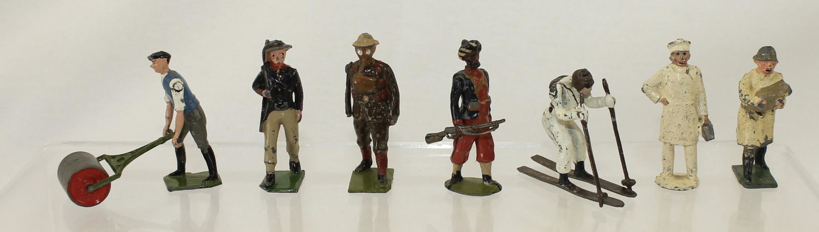 Assortment of Britains Figures: Britains. Lot includes Britains Man with Garden Roller Set 715, Italian Bersaglieri From Set 169, British Marching in Gas Masks From Set 298, 1st Madres Infantry, (Pre-War Circa 1899) From Set 67 and