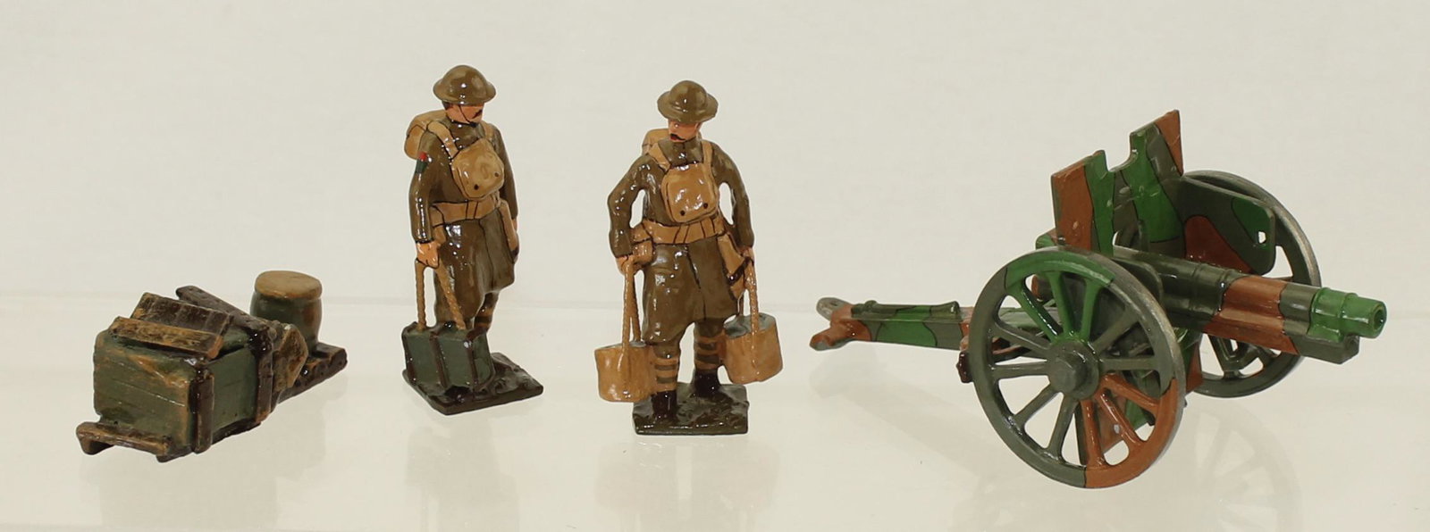 Tommy Atkins Lot British Infantry in Greatcoats: World War I. Lot includes British Army Gunner, Man Carrying Water Jugs and Supplies and a British Army Field Gun. 4 Pieces. Condition Excellent. No Box.