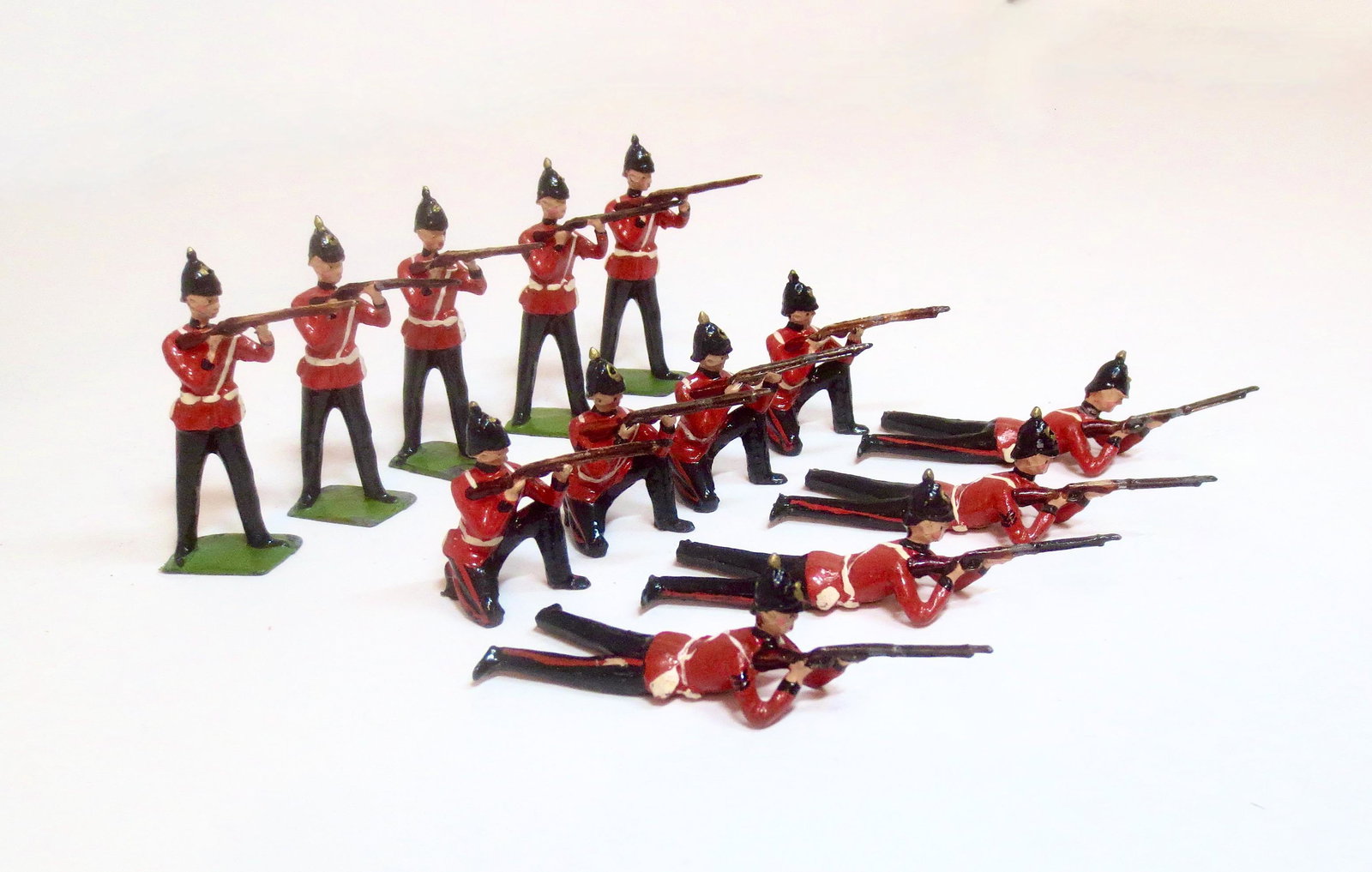 Britains From #2086 The Queen's Royal Regiment: West Surrey. Post war issue. 13 pieces (missing officer). Excellent condition (some embellished with rank stripes, numbers on base bottoms). Unboxed.