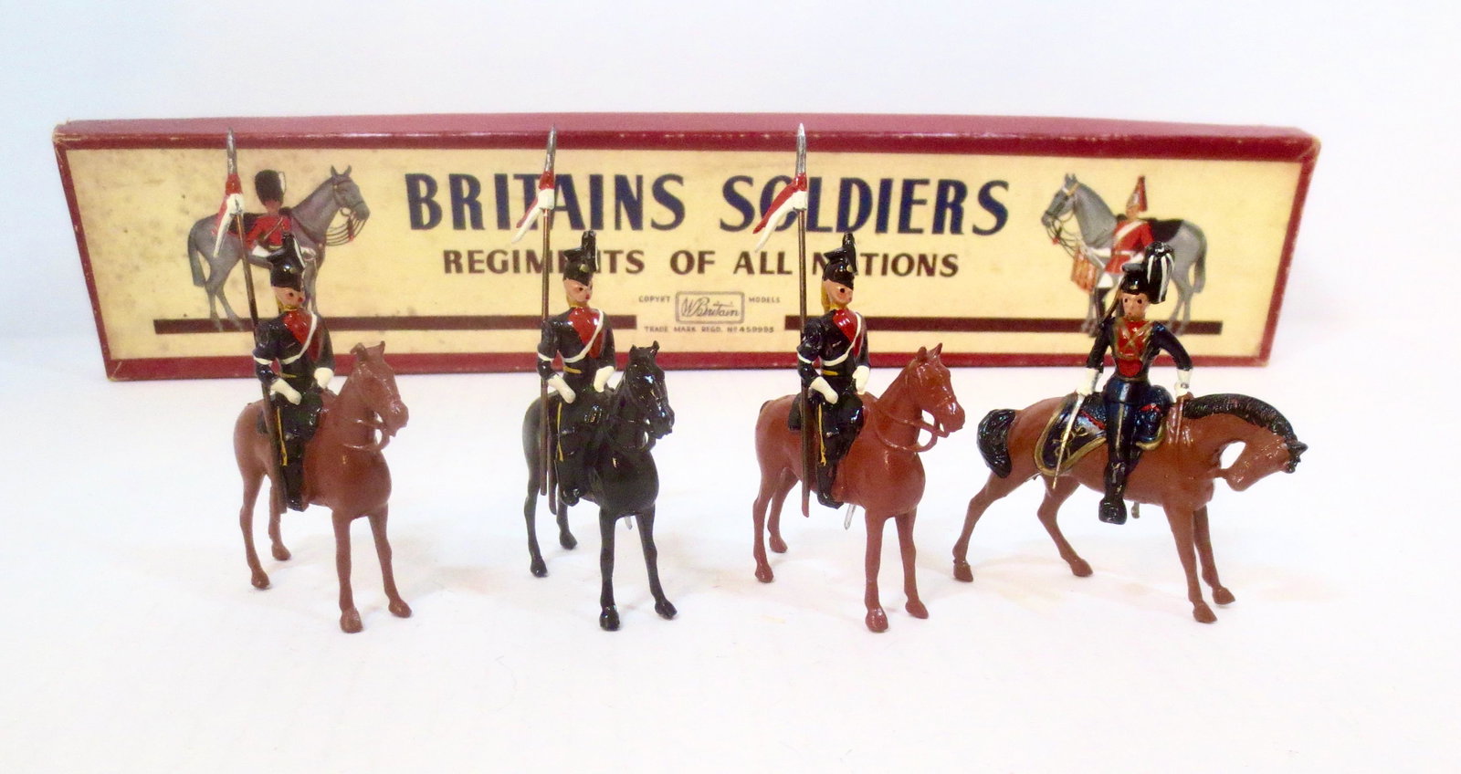 Britains #24 9th Queens Own Royal Lancers: Post war issue. 4 pieces. Near mint condition. ROAN box fair (two top corner splits and faded bottom).