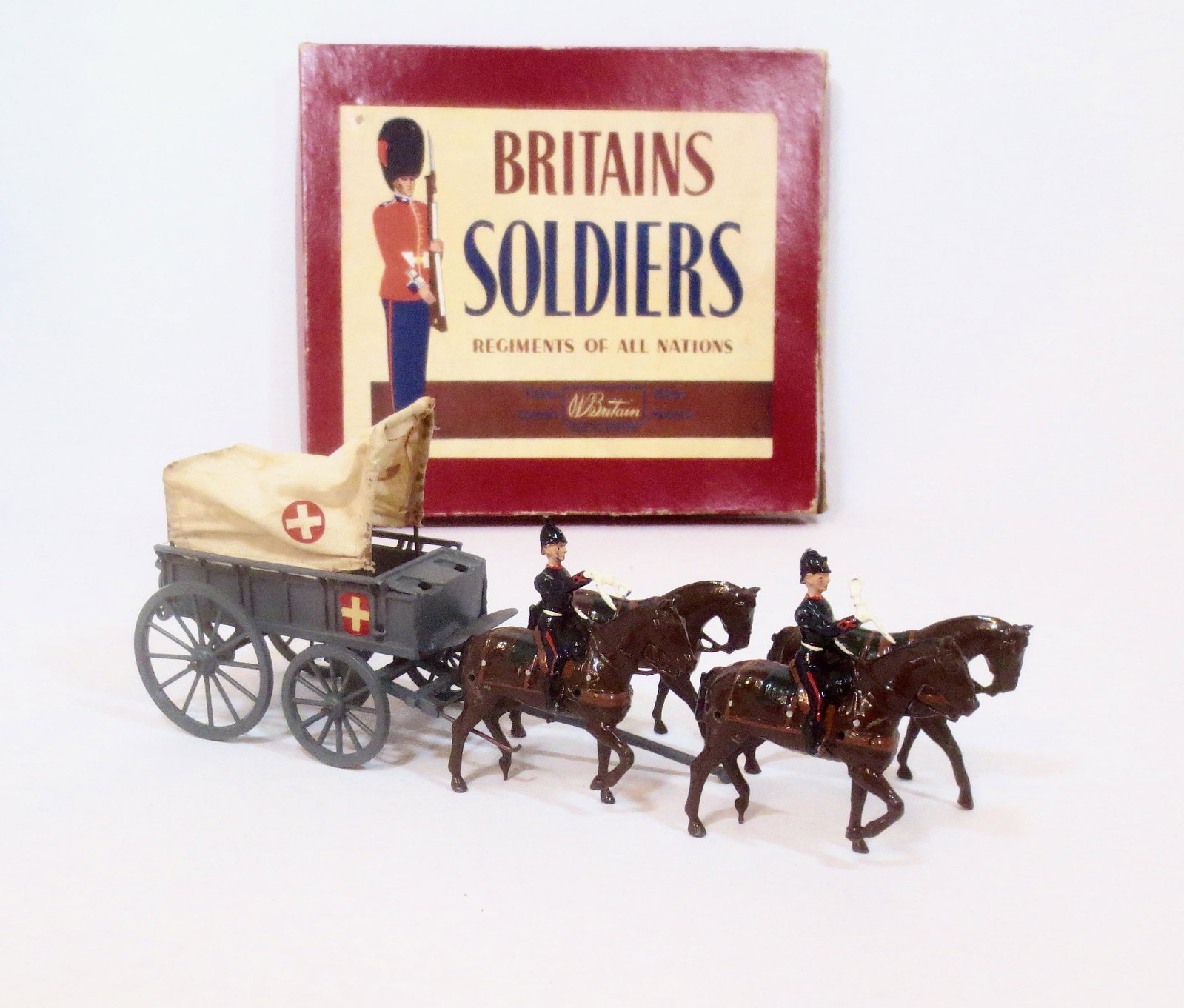 Britains #145 Royal Army Medical Corps Ambulance: Post war issue. 6 pieces, plus traces. Missing drivers and one helmet ball, the rest in very good condition. Box fair (3 top corner splits and one bottom corner split).