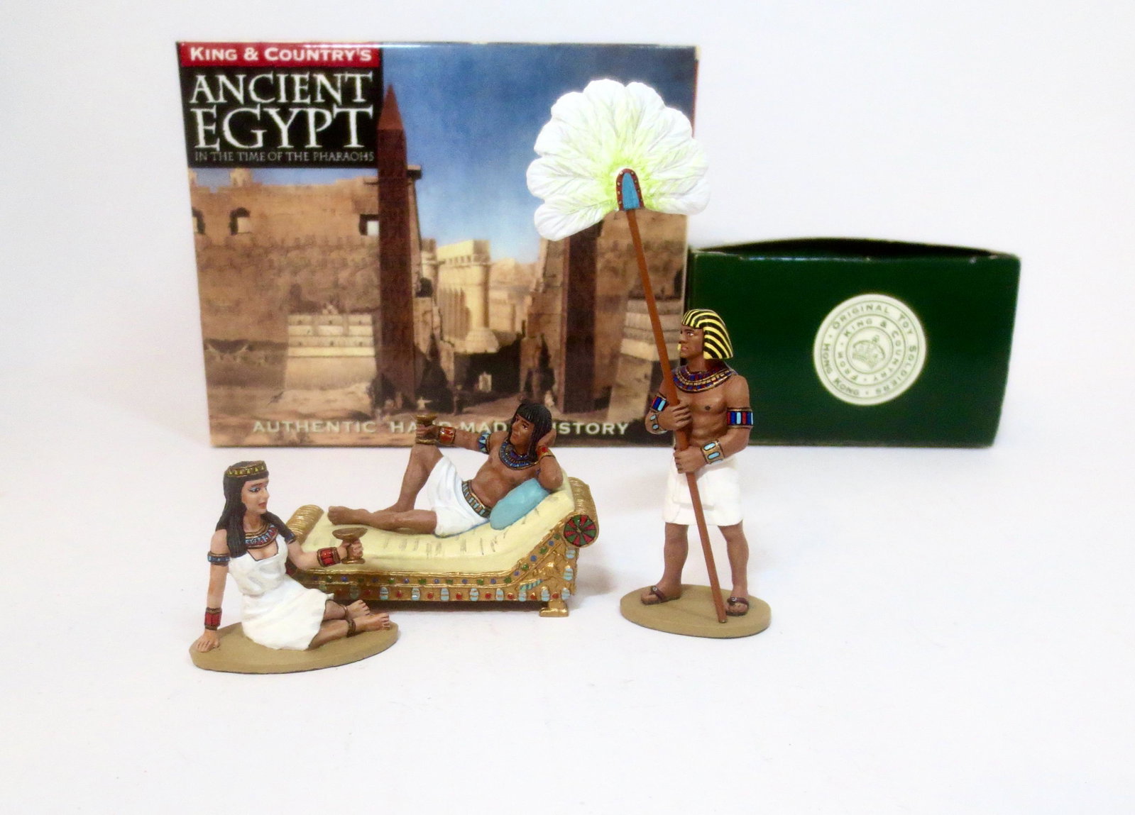 King & Country Ancient Egypt Series: An Egyptian Nobleman takes his ease on a reclining banquette. Sitting on the floor next to him…his favorite concubine #AE021, and Servant with Fan #AE002. 3 pieces. Mint condition. Boxes excellent.