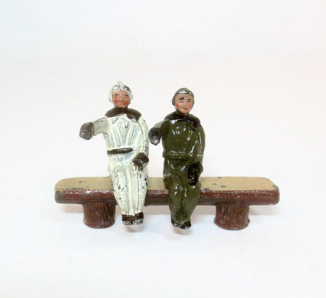 Britains Pre War Pilots: In White, and in Khaki. 2 pieces. Both excellent. Bench not included. Unboxed.