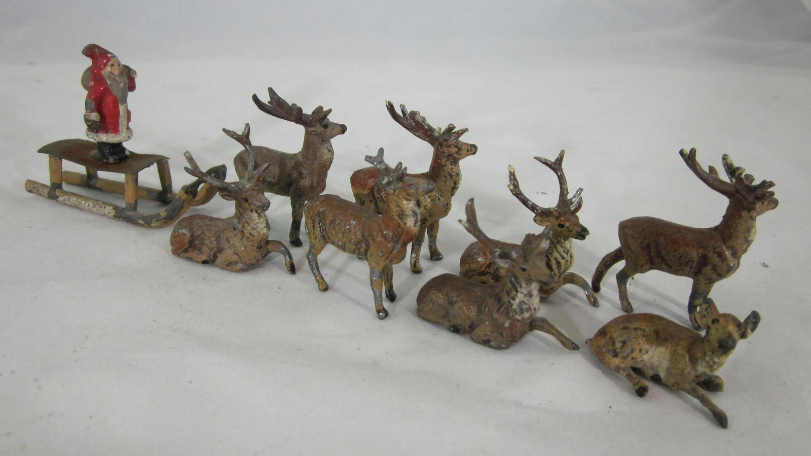 Heyde Christmas Sled And 8 Reindeer Vignette: UNBOXED Heyde Christmas Souvenir piece with 35mm bag-laden elf on sled led by 8 loose reindeer, circa 1930. Condition very good, elf right hand holding small piece of wire that was broken off. 1 reind