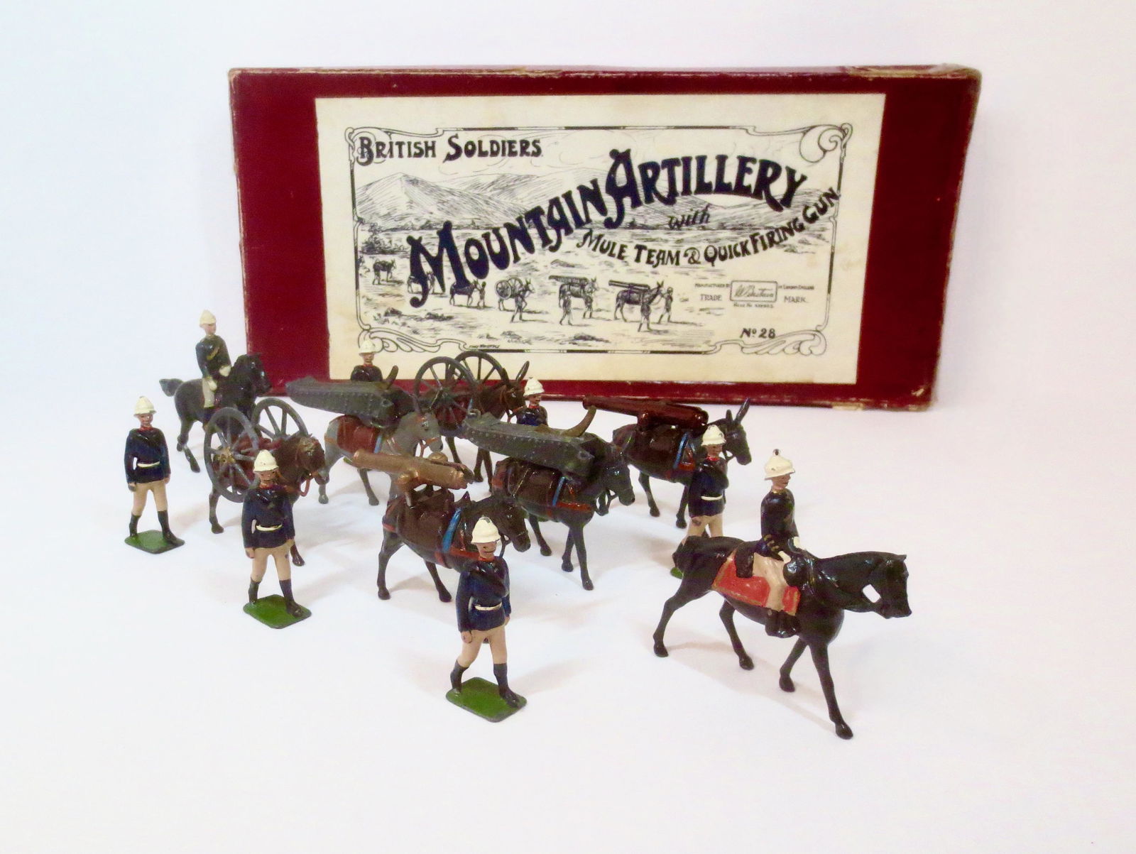 Britains #28 Mountain Artillery: With Mule Team and Quick Firing Gun. Pre war issue, with Whisstock illustrated label box. 20 pieces, includes two extra mules, and one additional post war officer. Excellent overall condition (one mul