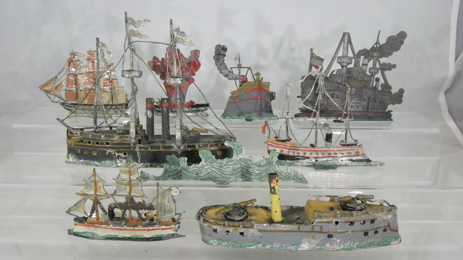 Heyde Hollowcast Naval Ship Battle.: UNBOXED Naval Battle of Ships. 3 fully ronde, measuring 17cm, 16.5cm, and 10cm, with 5 more flat ships and 1 translucent blue waves. Condition is good-excellent. Largest ship has bent lanyards and mis