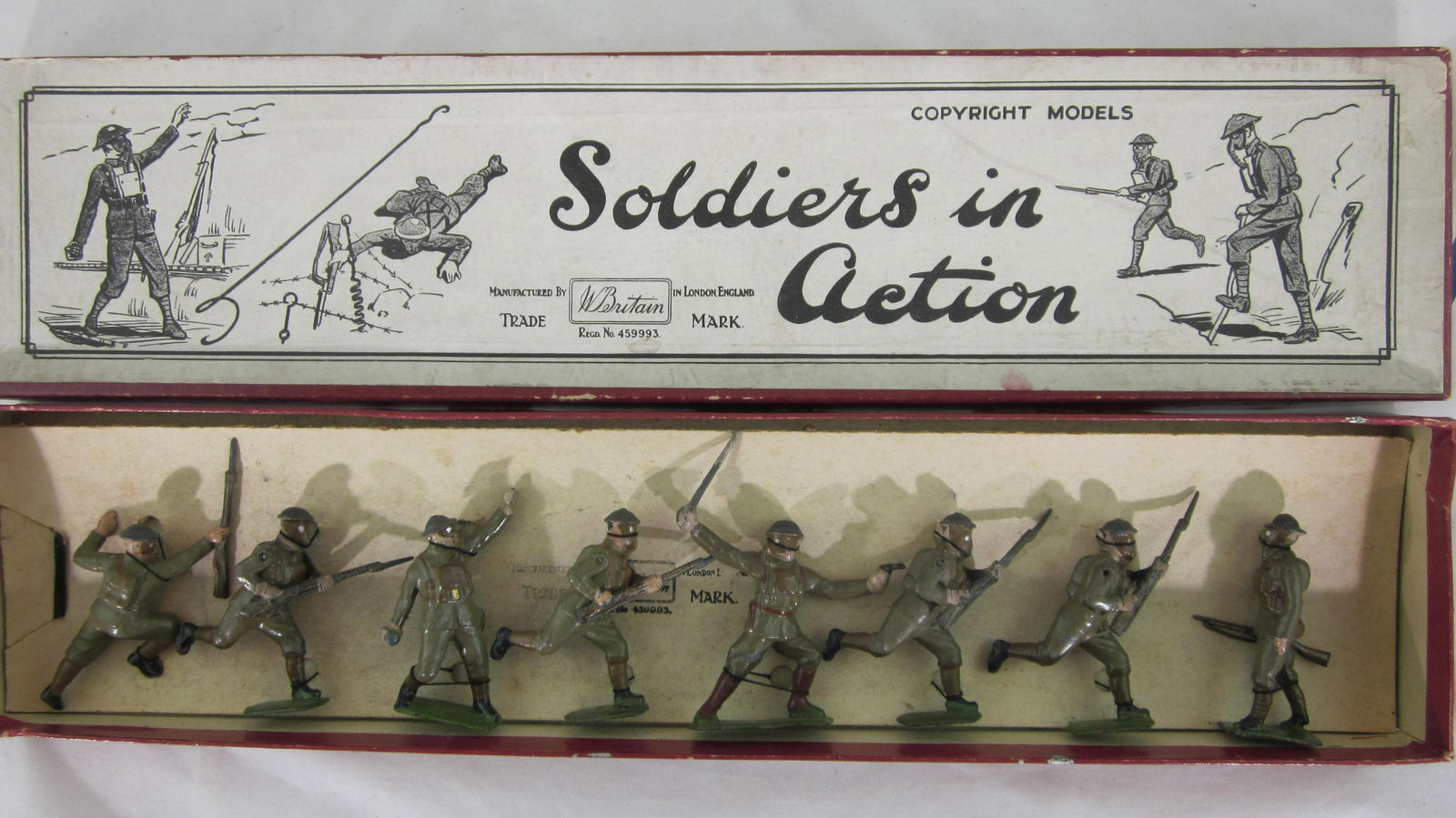 Britains set #1611 British Infantry In Action.: Boxed Gasmask Infantry set circa 1938 including matched officer, 4 charging, 1 crawling, 1 grenade, 1 at trail, all in early grey helmets. 8 Pieces. Condition excellent in excellent Soldiers in Action