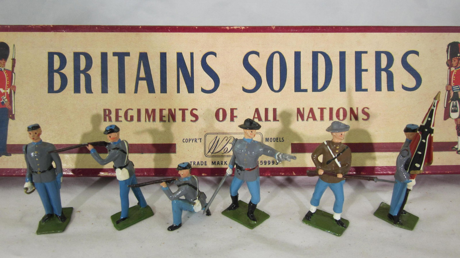 Britains Set #2060 Confederate Infantry.: Boxed Confederate Infantry, complete 6 pieces as issued circa 1963-1966. Condition excellent in very good ROAN box with white stamped end label and correct tie card. Tray has split on 1 side flap.