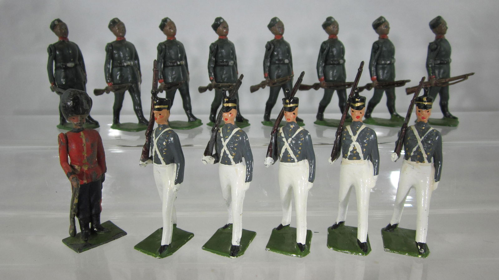 Britains Foot Soldier Medley.: UNBOXED #197 Gurkhas at trail (1 rifle butt gone), #299 West Point Cadets and a #111 Grenadier Guard at attention (rifle tip missing). 14 pieces, condition very good-excellent. No box.