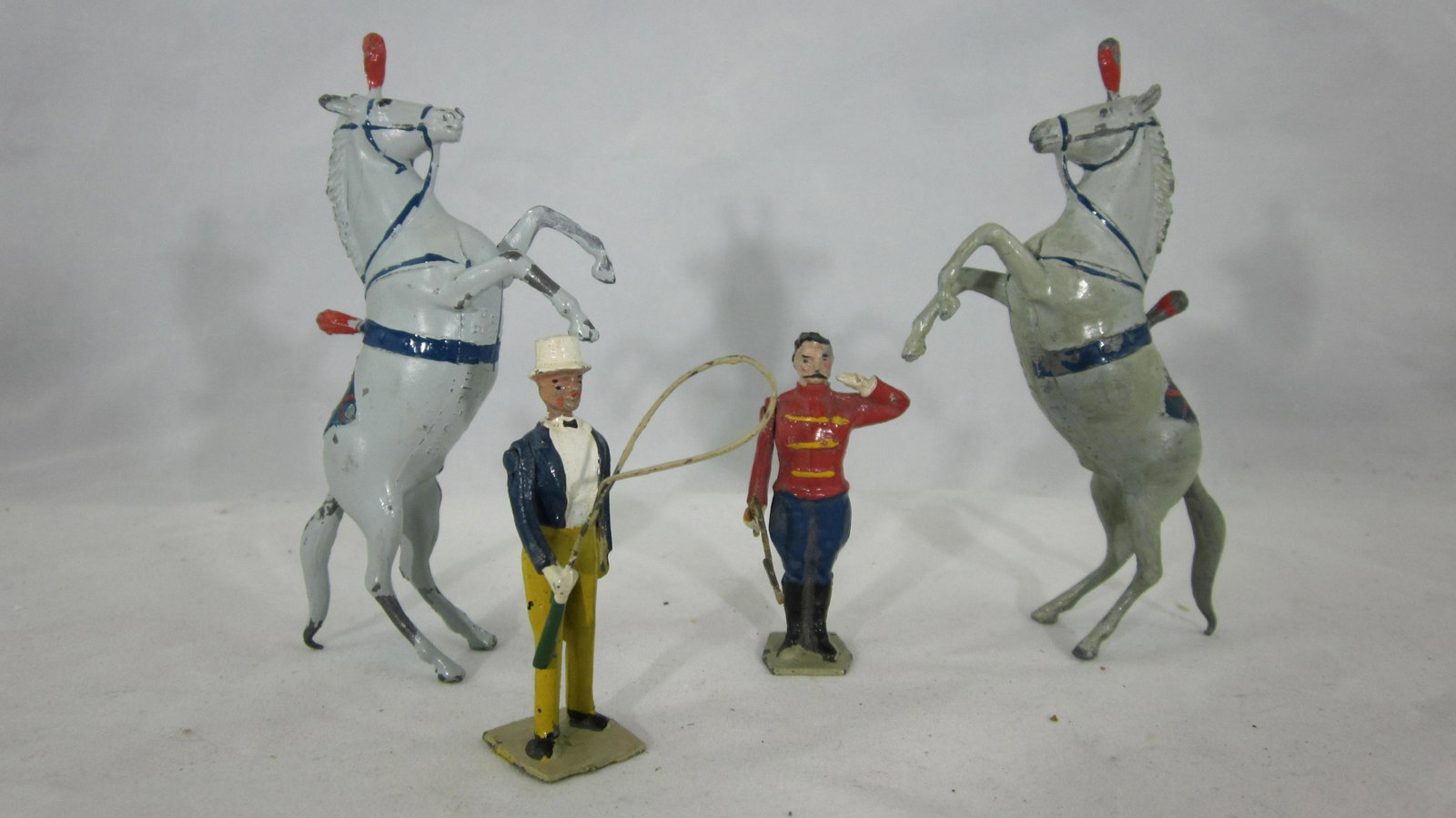 Britains Lion Tamer, Ringmaster And Horses.: UNBOXED #448B Tamer, #357B Ringmaster and 2 #351B Performing horses. 4 pieces from Circus Series. Condition very good. No box. Circa 1950s.