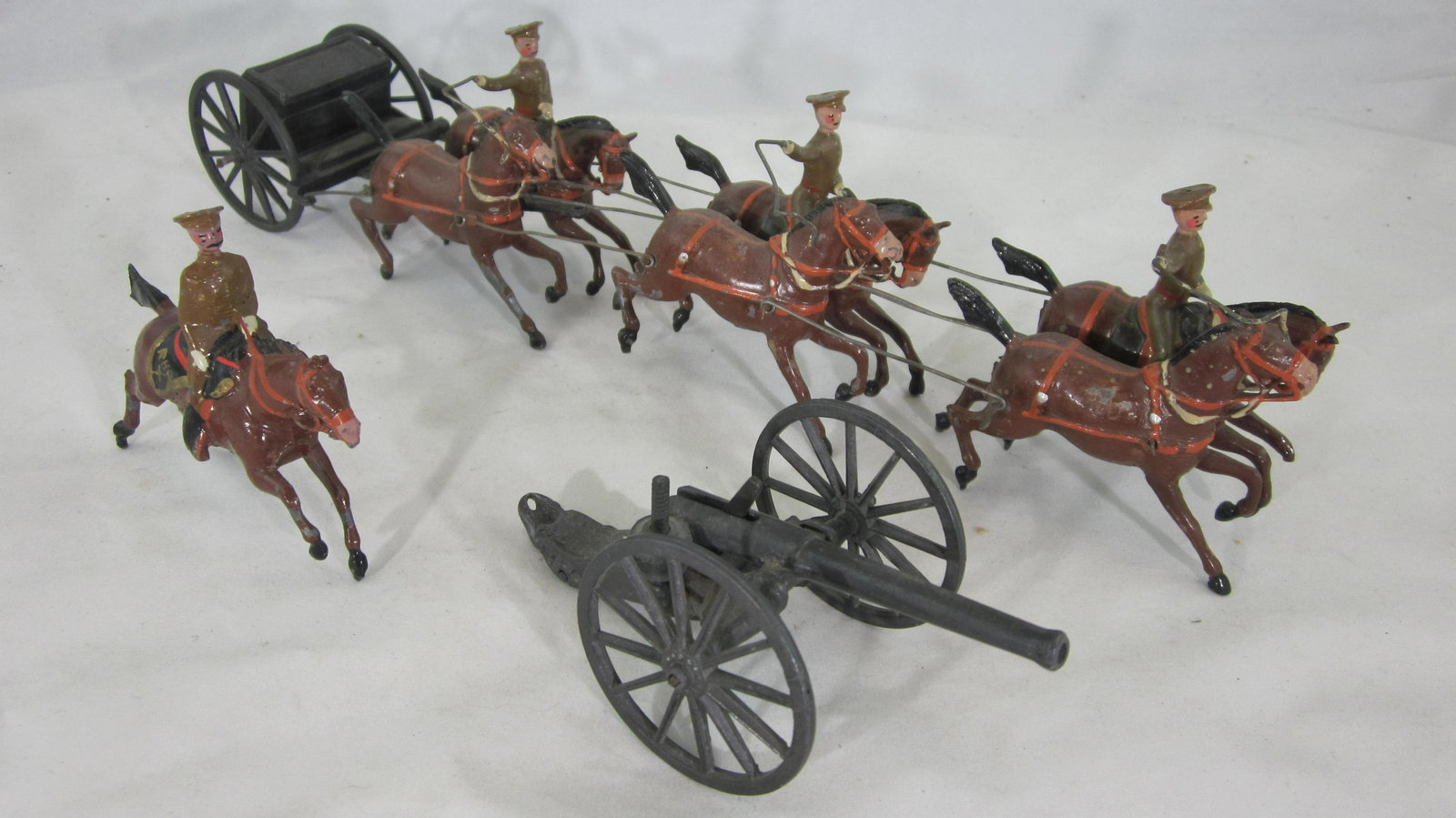 Britains Set#39A Active Service Royal Artillery.: UNBOXED Royal Horse Artillery at gallop. No box in Khaki, peak caps, early version fumed metal gun and limber, fixed arm Mounted Officer but missing 4 outriders. 9 pieces circa 1920s, condition very g