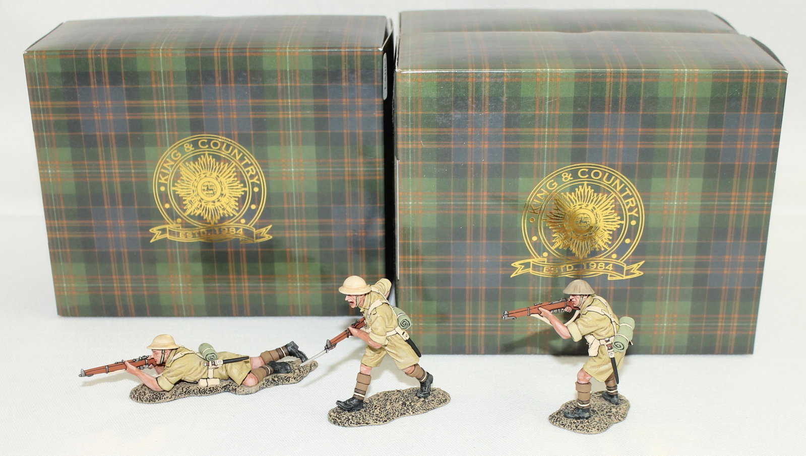 King & Country Lot British Riflemen: British Eighth Army. Lot includes Set #EA082 Rifleman Lying and Firing and Set #EA083 Charging with Rifle with Bayonet and Set #EA084 Standing Firing. 3 Pieces. Condition Excellent. Boxes Excellent.