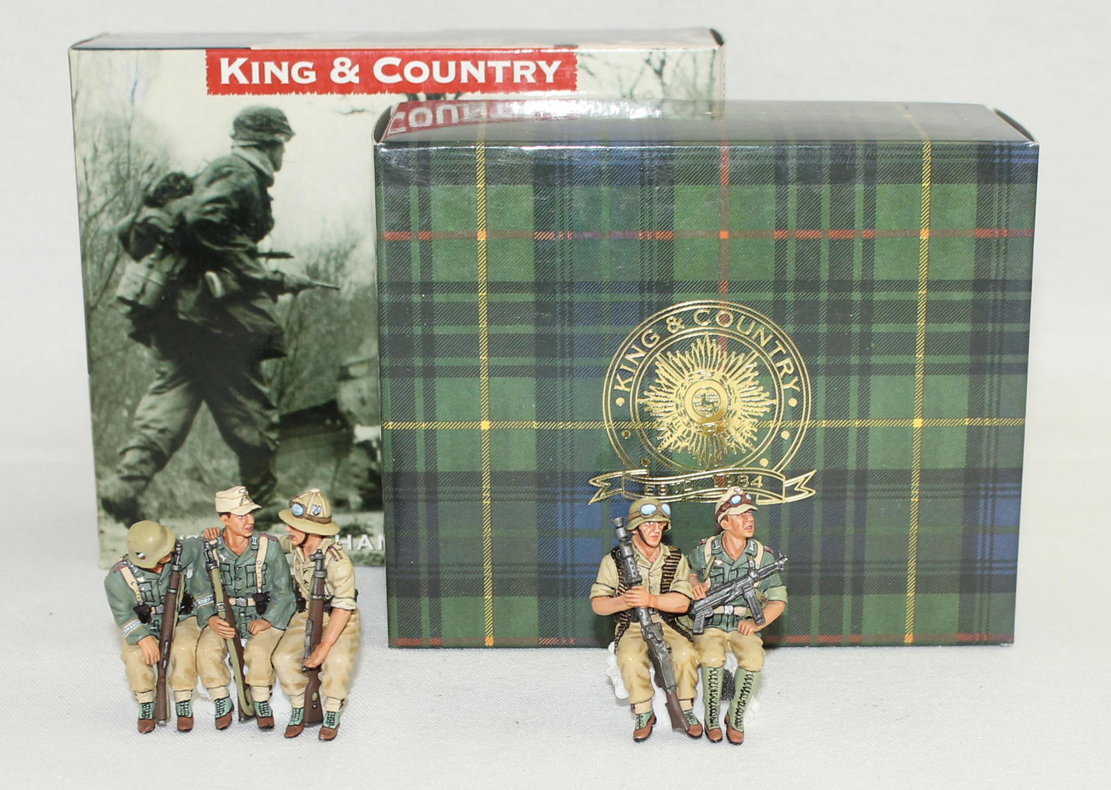 King & Country Lot Vehicle Passengers: German Afrika Korps. Lot includes Set #AK044 Vehicle Passengers and Set #AK045 Passengers Carrying MG34 and MP40. 2 Pieces. Popular Set. Condition Excellent. Boxes Excellent.