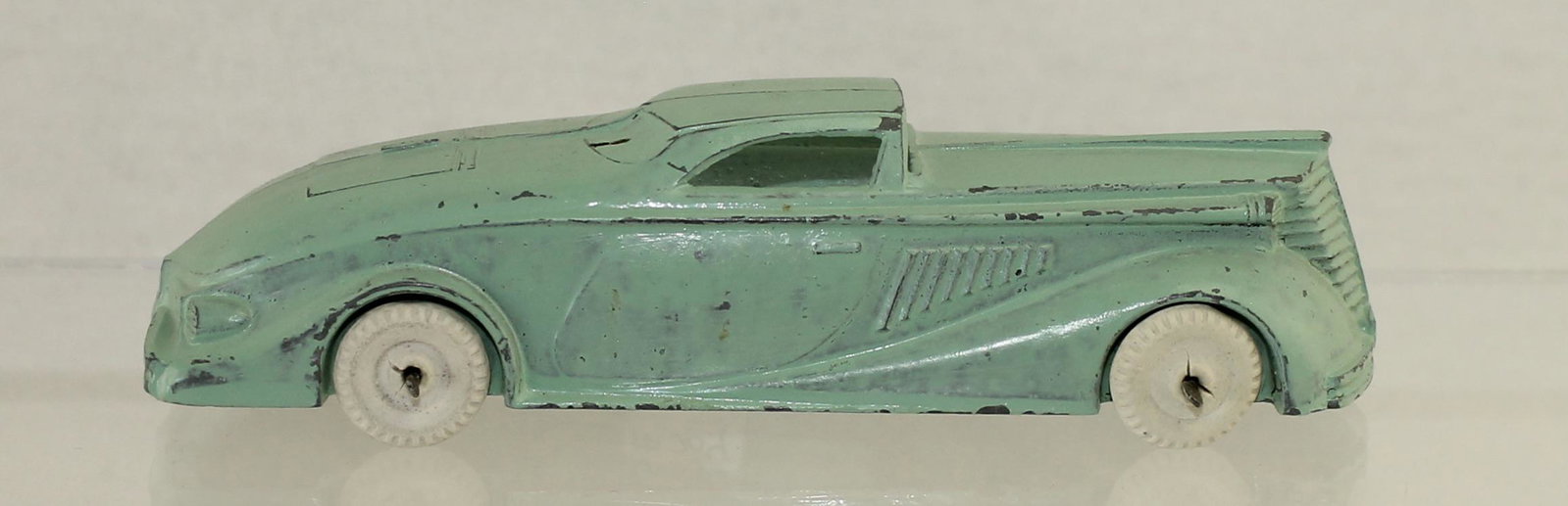 Manoil #704 Futuristic Roadster: Pre War. Includes White Rubber Tires. 1 Piece. Condition Very Good to Excellent. No Box.