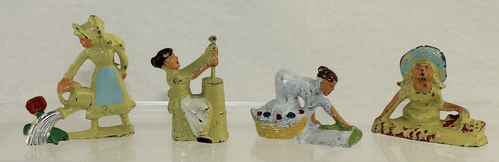 Manoil Lot Women Doing Chores: Happy Farm Series. Lot includes M159 Girl Watering Flowers, M161 Woman with Butter Churn, M162 Woman Laying out Wash, M166 Girl Picking Berries. 4 Pieces. Condition Very Good to Excellent. No Box.