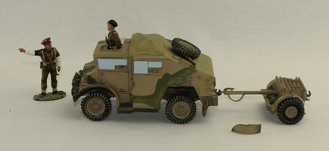 King & Country EA005 Field Gun Tractor: British Eighth Army. Field Gun Tractor with Limber. 5 Pieces. Condition Good to Very Good. Paint Wear to MP's Hat. Piece of Fender Broken on Trailer But Present. No Box.