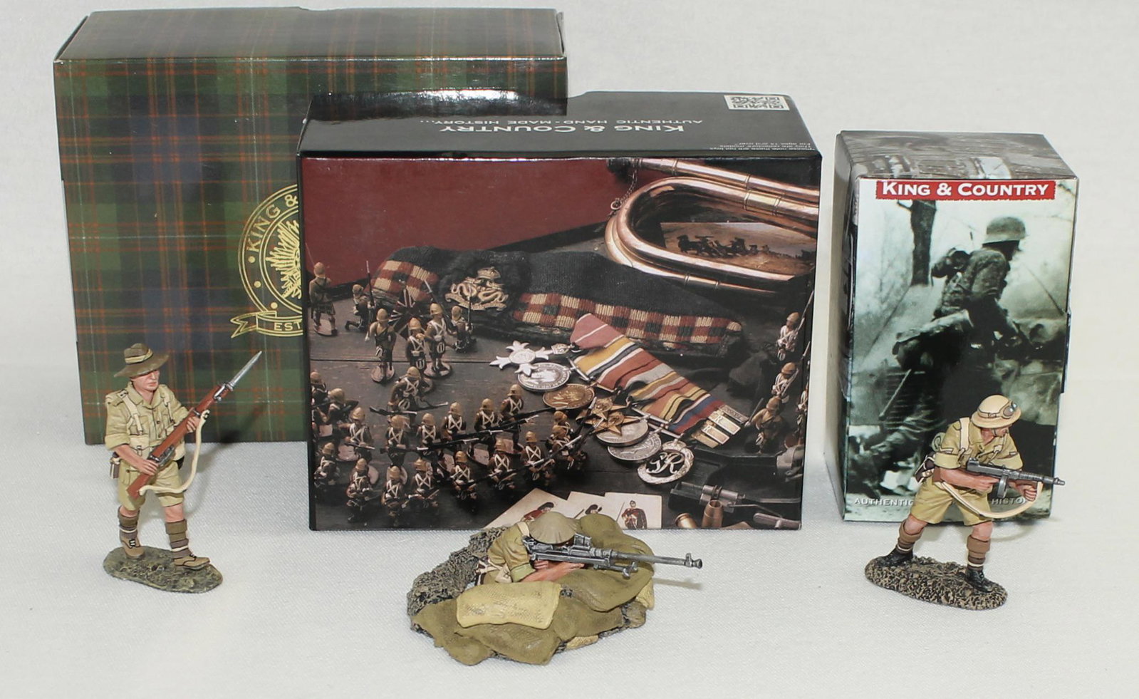 King & Country Lot Australian Infantry: British Eighth Army. Lot includes Set #EA068 Aussie Sergeant with Tommy Gun, Set #EA070 Aussie Advancing with Rifle and Set #EA126 Trench with "Boys" Anti Tank Rifle. 4 Pieces. Condition Excellent. Bo