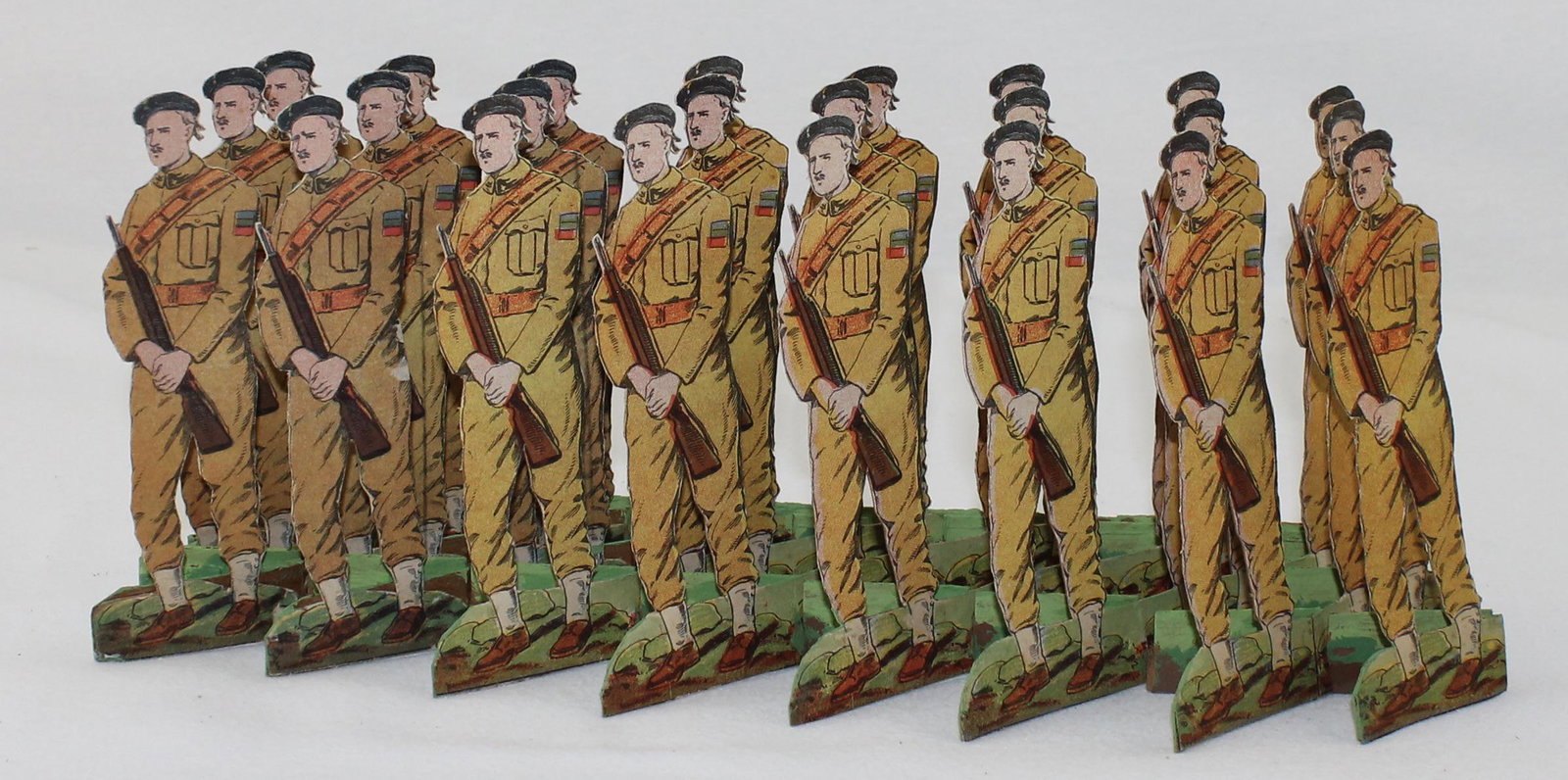 Articulated Cardboard British Soldiers: Cardboard Soldiers Depicting the British Army. Circa 1940's. 24 Soldiers on One Accordion Style Pull Out Base. Maker Unknown. Measures 5" Tall. 1 Piece. Condition Good. One Fold Separated. No Box.