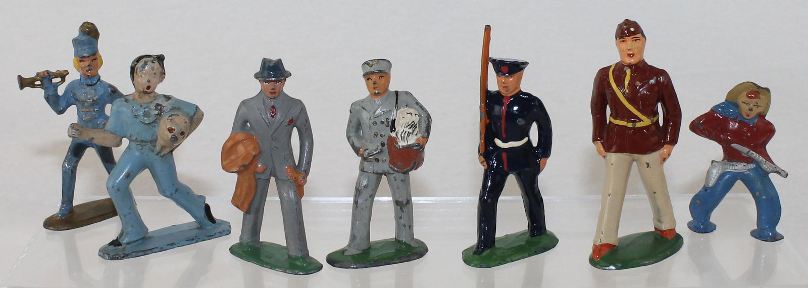 Barclay Lot Civilians: Dimestore Series. Lot includes #B59 US Marine, #B158 Gentleman with Coat, #B189 Mailman, #B248 Cowboy, #B149 American Legion by Vintage Castings, Lady with Pig by Tommy Toy and a Bugler by All-Nu. 7 P