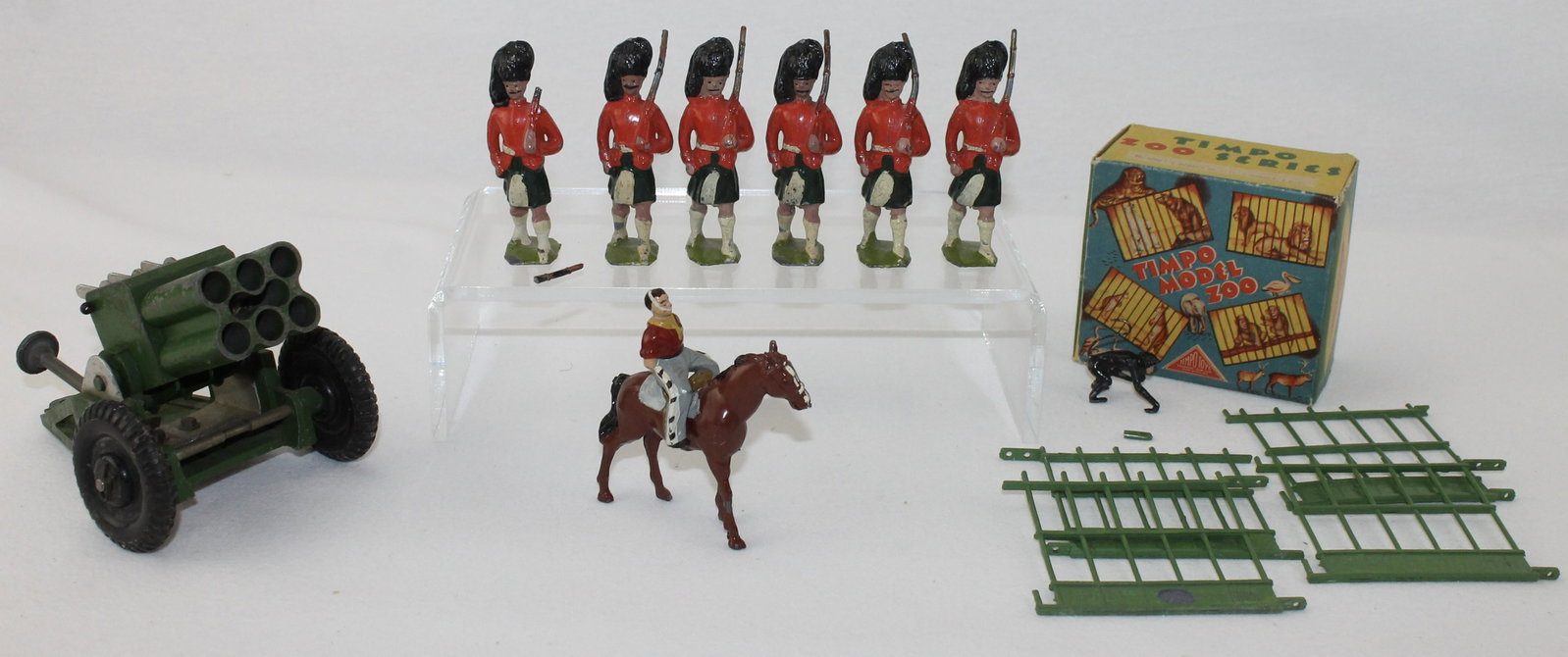 Lot of British Made Lead Figures Rocket Launcher: Lot includes Rocket Launcher with Rubber Wheels by Astra, 6 Britains Large Scale Highlanders, Johillco Horse with Timpo Rider and a Partial Timpo Set #4202 Zoo Series Cage Enclosure and Monkey. 15 Pie