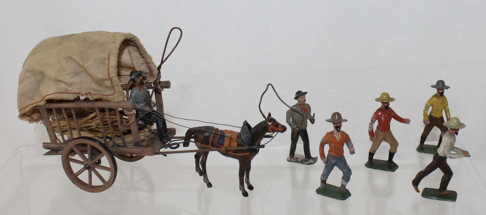 Heyde Lot Boer War Supply Wagon: Size 2 (48mm). Supply Wagon with Driver Pulled by First Quality Horse, Wheat Sheafs and 5 Boers on Foot. Canvas Canopy on Wagon. Scarce Wagon. 7 Pieces. Condition Good to Very Good. Canopy Loose. No B