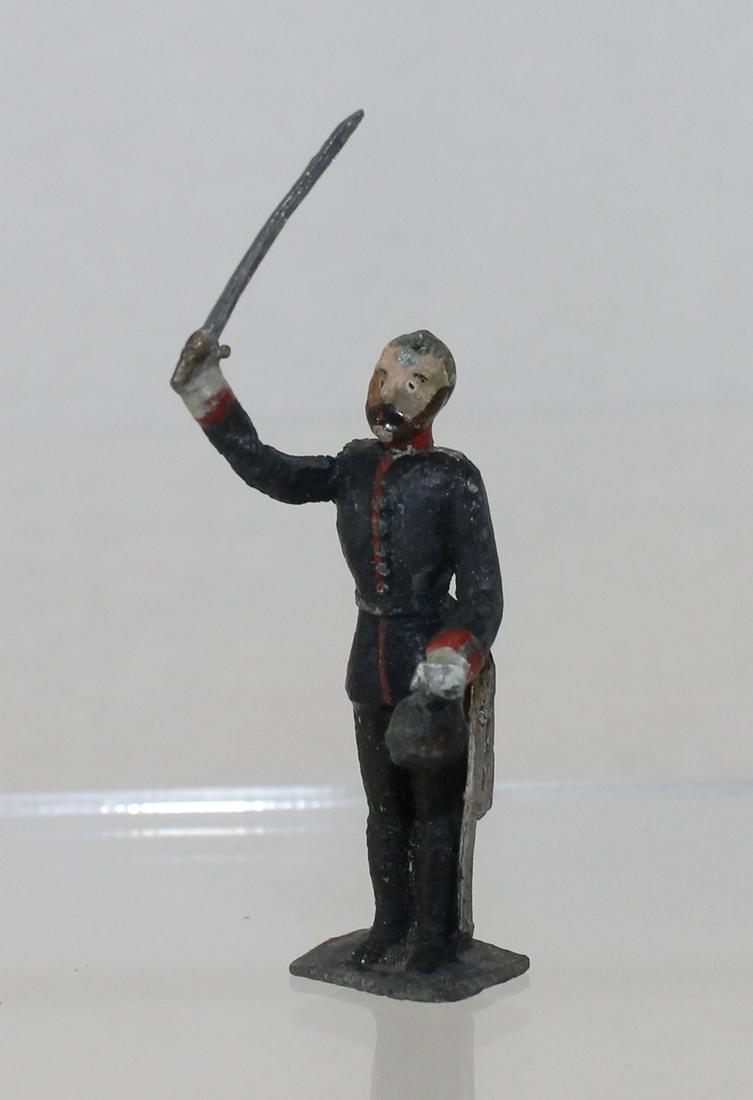 Heyde Military Personality: Size 2 (48mm). Unknown Personality with Raised Sword and Holding Pickelhaube. Seldom Seen. 1 Piece. Condition Fair to Good. Slight Retouch to Uniform. No Box.