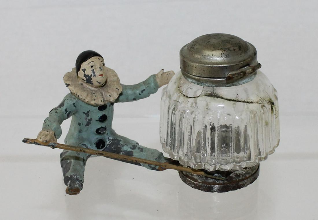 Heyde Souvenir Ink Well with Clown: Nippes Figure. Glass Ink Well with Seated Lead Clown. Metal Top on Ink Well. 1 Piece. Condition Good. No Box.
