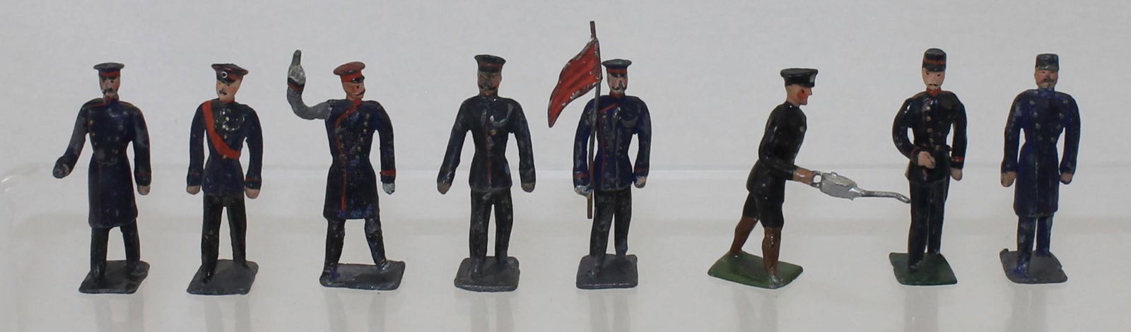 Heyde Lot Railroad Station Staff: Size 2 (48mm). Lot includes Man with Red Caution Flag, Man with Oil Can, Assortment of Figures in Long and Short Coats. 8 Pieces. Condition Good. No Box.