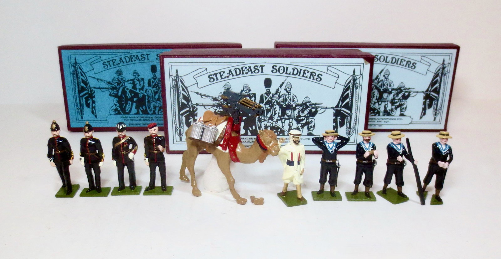 Steadfast #SF22 Military Police: Plus Royal Navy Gun Team #SF77, and Camel with Gatling Gun & Handler #SF80. 10 pieces. Foot broken off Camel, but included for repair. Others in mint to near mint condition. Boxes excellent to very go