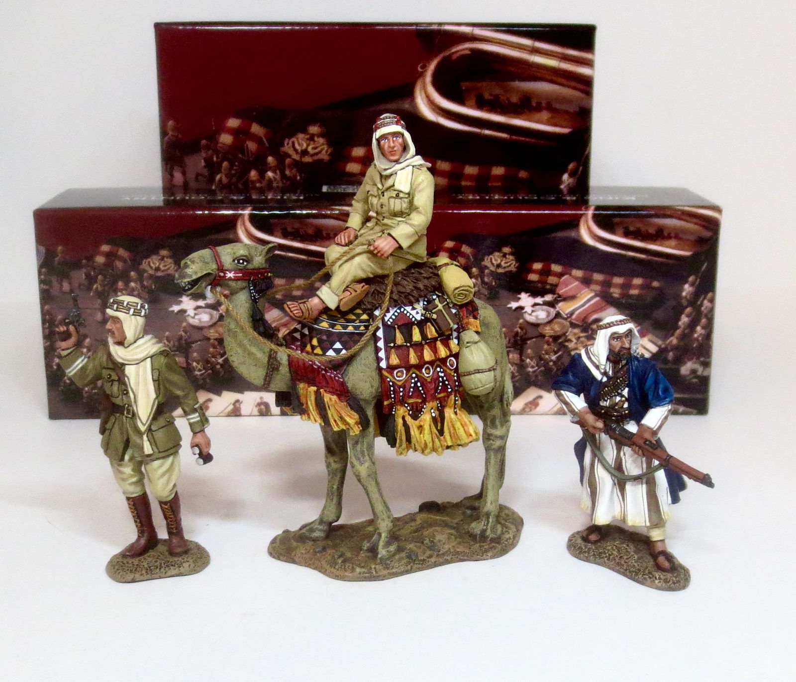King & Country Lawrence of Arabia Figures: Lawrence mounted on camel #LOA14, Major Garland #LOA009, and Arab loading rifle #LOA010. 3 pieces. Mint condition. Boxes excellent.