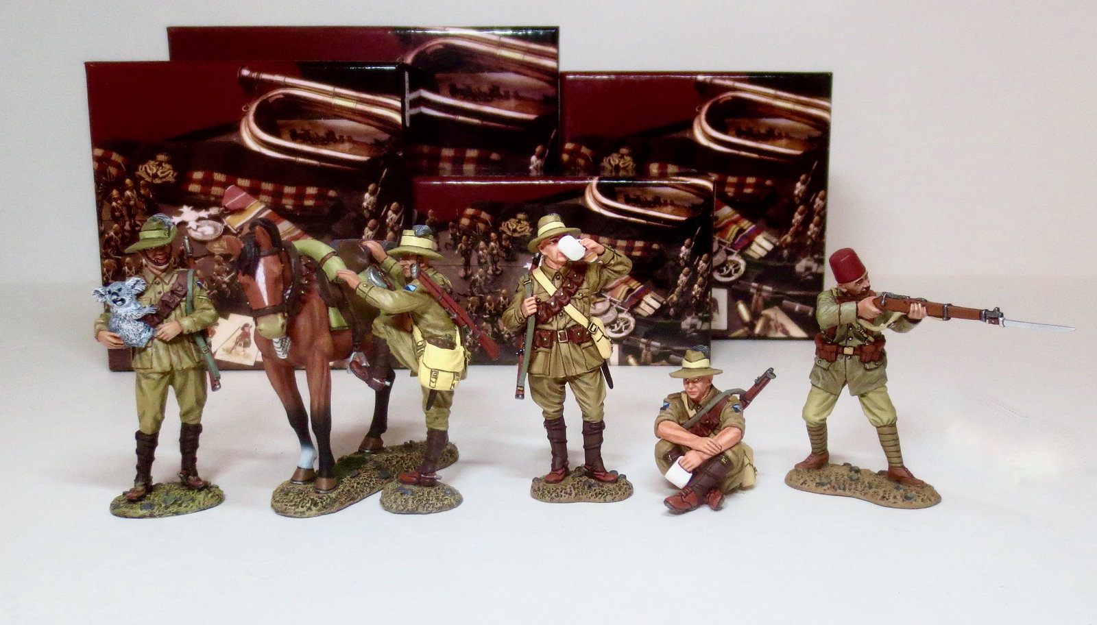 King & Country Australian Light Horse Figures: Horseman with Koala #AL101, Trooper mounting up #AL108, Troopers enjoying a brew #AL077, and Turkish NCO firing rifle. 6 pieces. Mint condition. Boxes excellent.