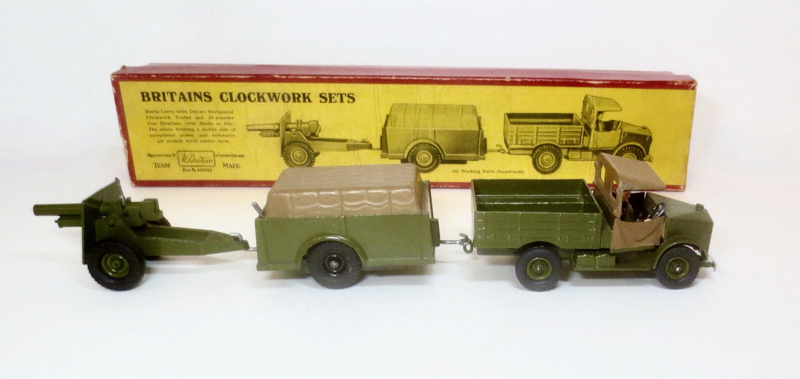 Britains #2048 Clockwork Set: Post war issue, circa 1950-1960. Beetle Lorry with driver towing mechanical clockwork trailer and 25 pounder gun. Near mint to excellent working condition (key stuck in wind-up hole). Box very good.