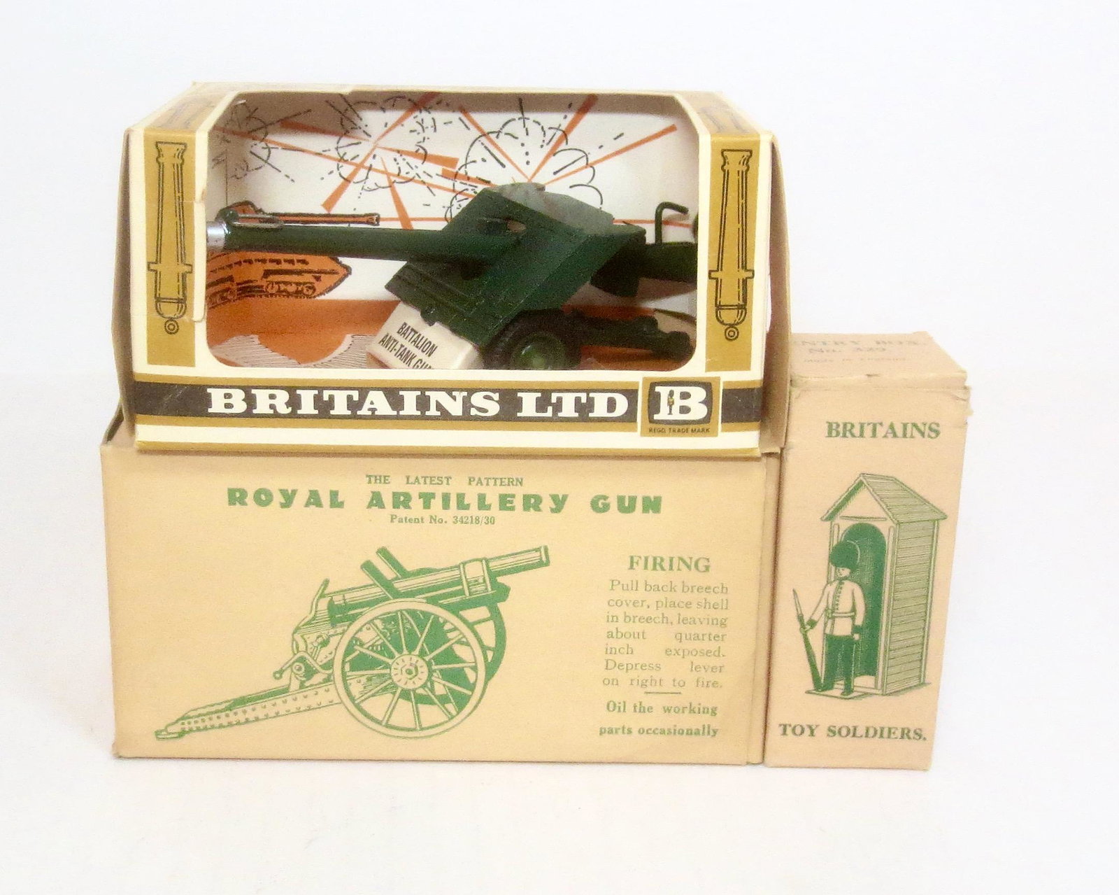 Britains Post War Assortment: B.A.T. Gun #9720 in near mint condition (box missing cellophane window), Royal Artillery Gun #1201 in mint condition with an excellent box, and Sentry Box set #329 in near mint condition with an excel