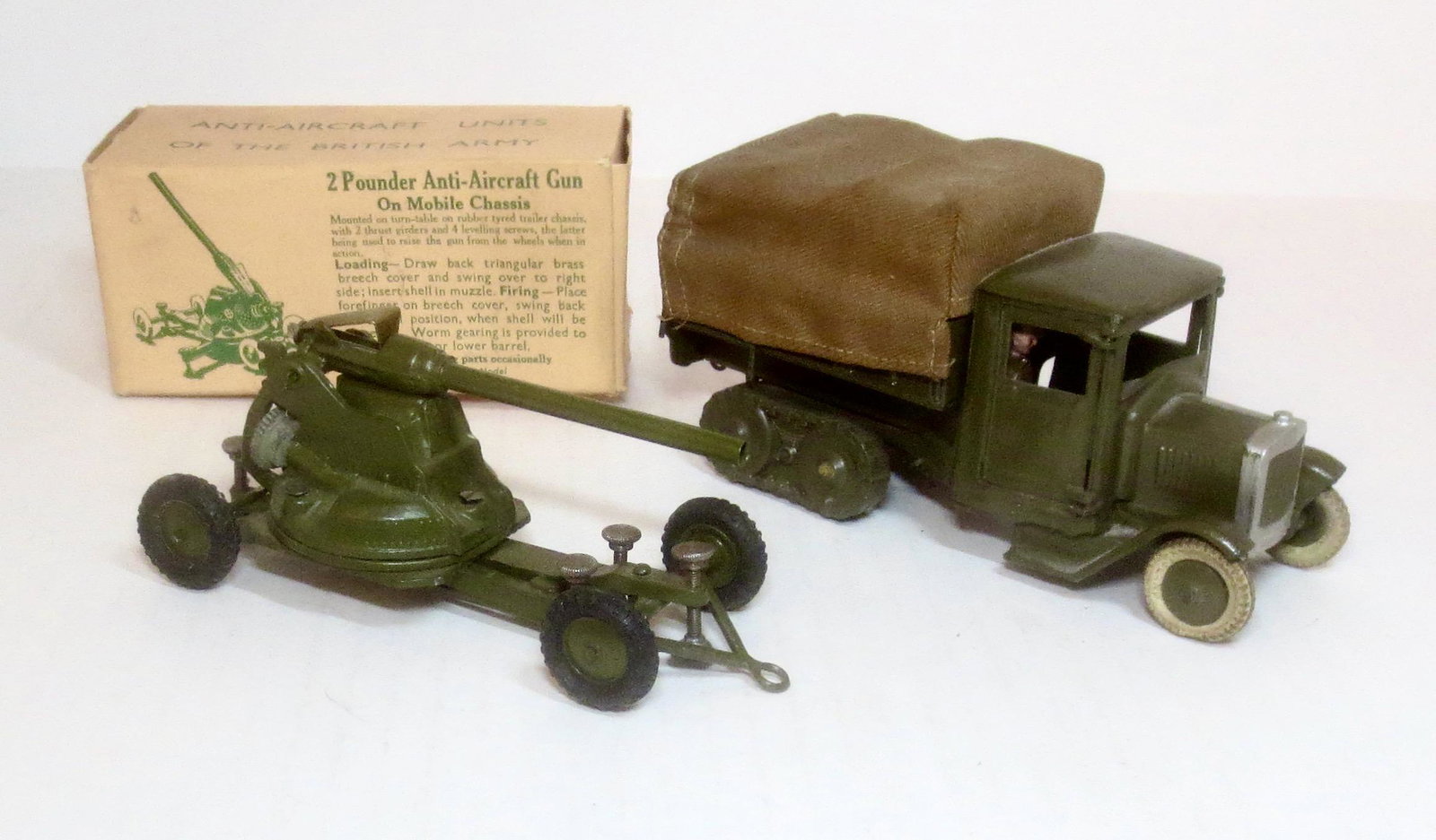 Britains #1717 2 Pounder Anti Aircraft Gun: on mobile Chassis, in excellent condition with a very good box (one bottom puncture). And, #1433 Covered Army Tender with Driver in excellent condition, no box.