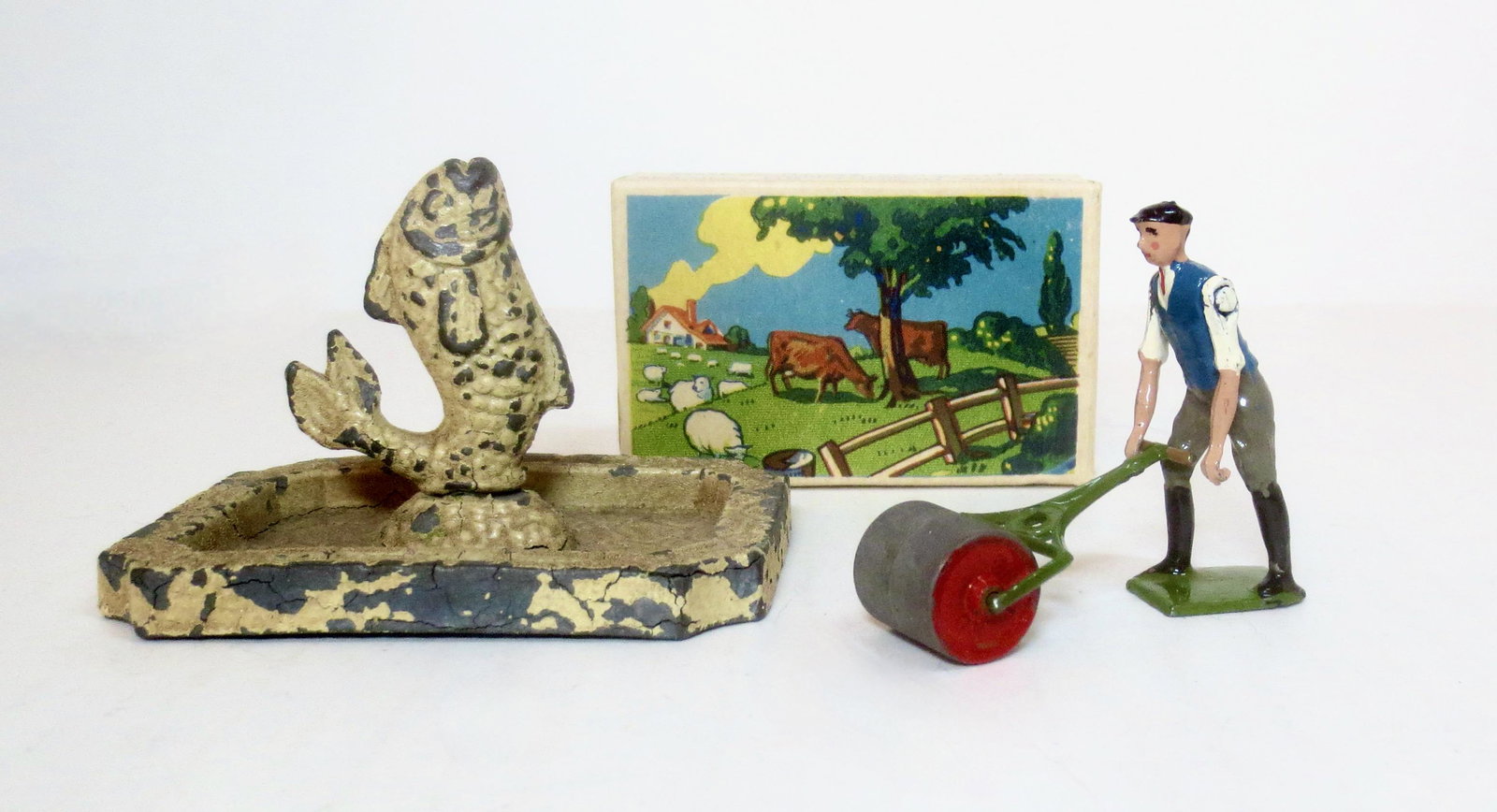 Britains #5032 Gardener with Roller: And, Fish Fountain. Gardener set in mint condition with an excellent box. Fountain complete but with paint loss, Unboxed.