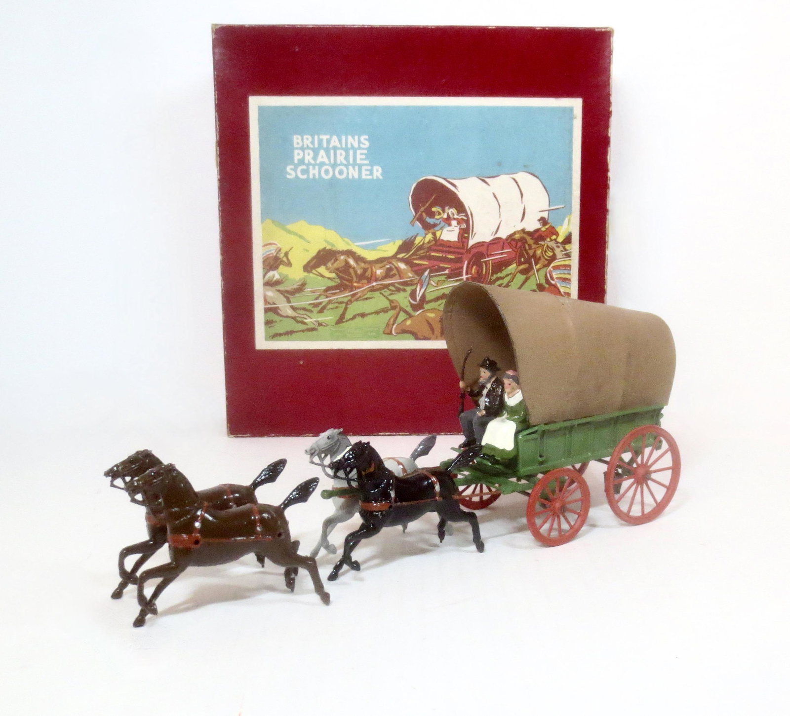 Britains #2034 Prairie Schooner: Post war issue. 8 pieces (plus traces). Set also includes both tin and fabric tops. 8 pieces. Excellent condition (tin top repainted). Box good (two top corner splits).