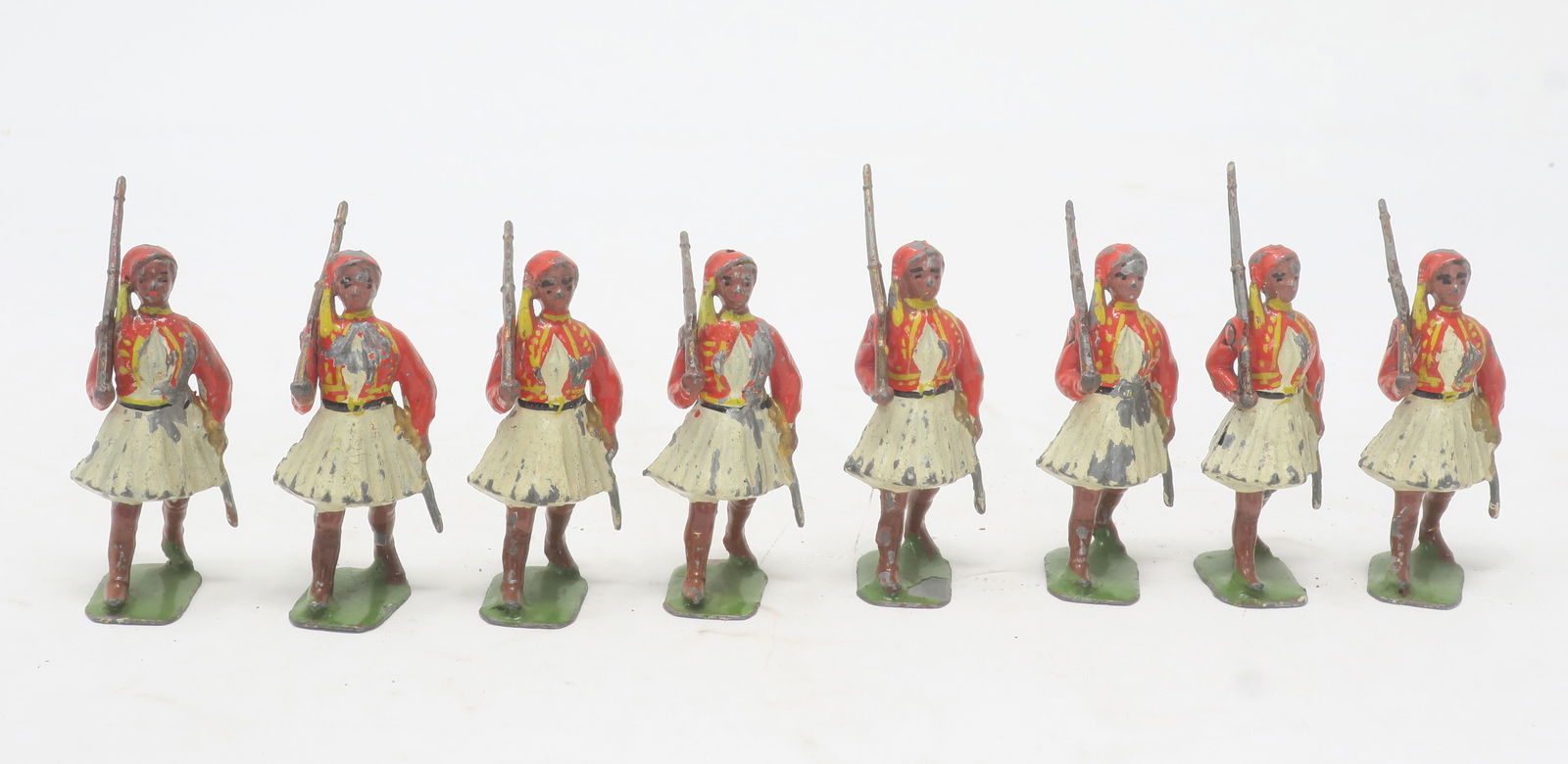 Britains set #196, Greek Infantry Evzones: at the slope, red tunics, fair-good, some chips on chests, etc, 8 pieces, (c. 1938)