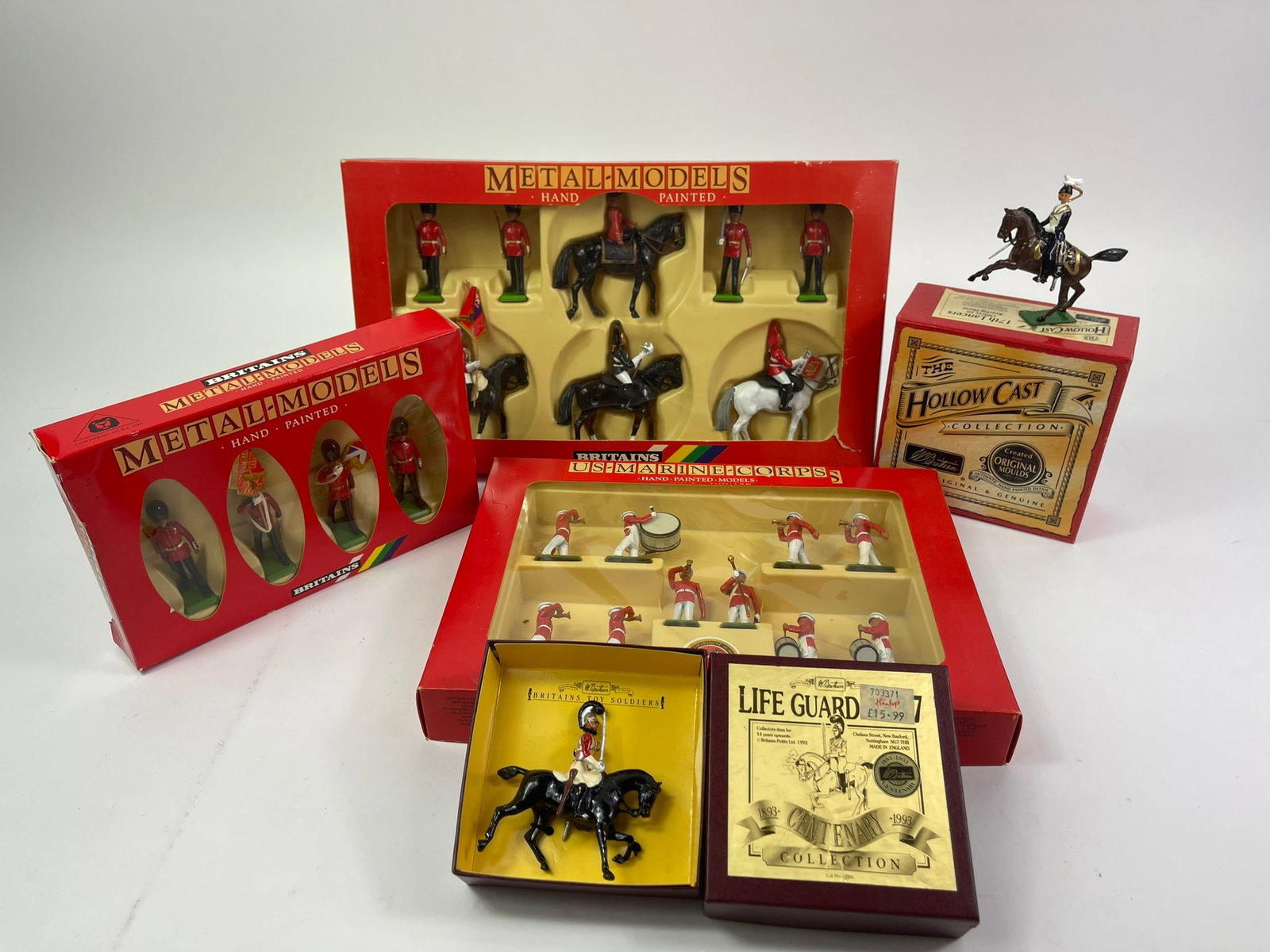 Britains Queen's, Lancers, U.S. Marine Corps: 5 complete sets with original boxes, in excellent to near mint condition. Sets included are #7218 "Her Majesty, Queen Elizabeth with Mounted Life Guard Standard Bearer, Trumpeter, Farrier, and Scots G