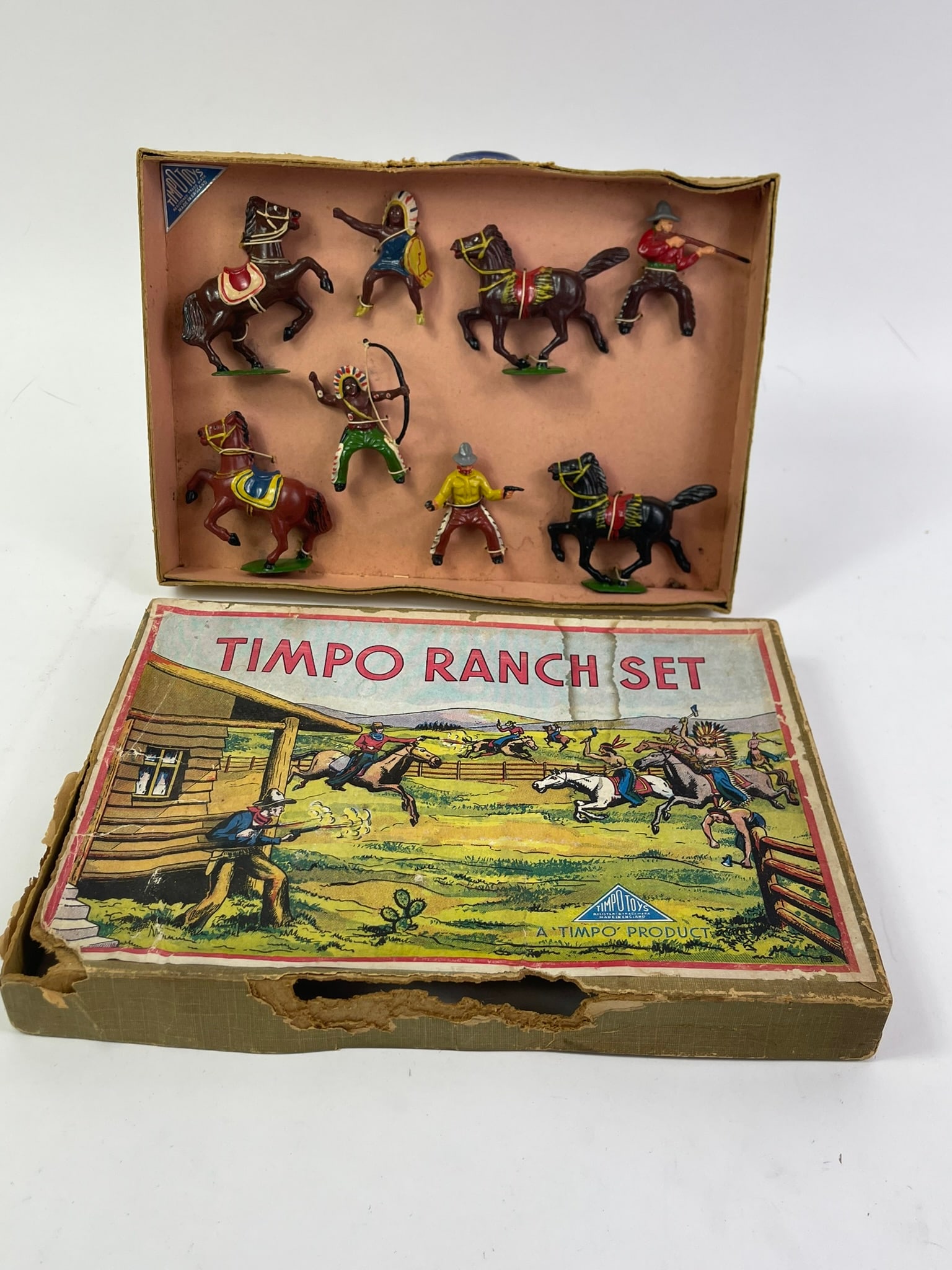 Timpo Ranch Set: 8 pcs with original box, figures still tied to tie-card. From Wild West Series set #235. Bandit's gun barrel broken and missing. Box is in fair condition.