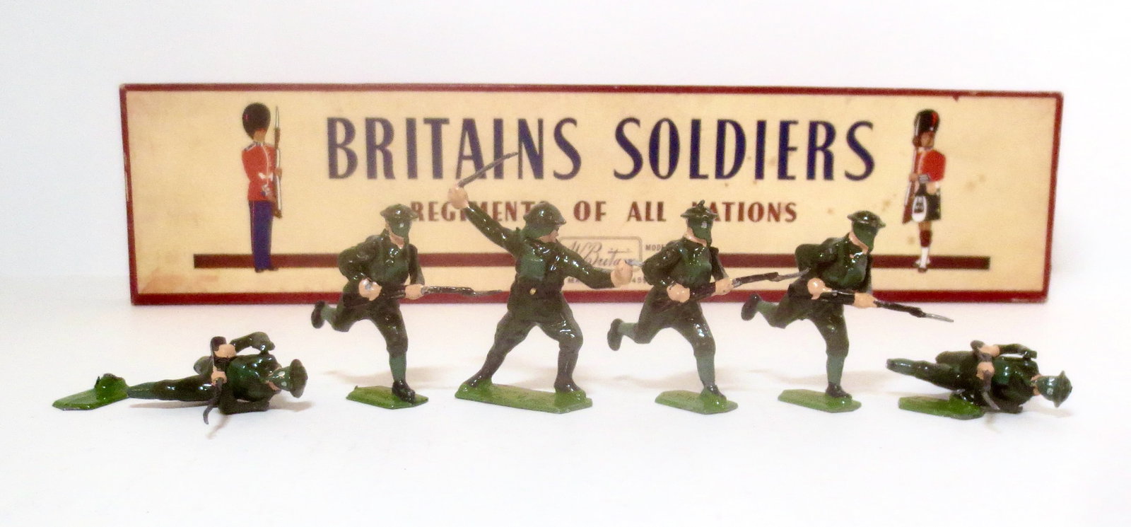 Britains #1613 British Infantry in Action: Charging with Gas Masks. Post war issue. 6 pieces. Two broken from bases, the rest in excellent condition. Box excellent.