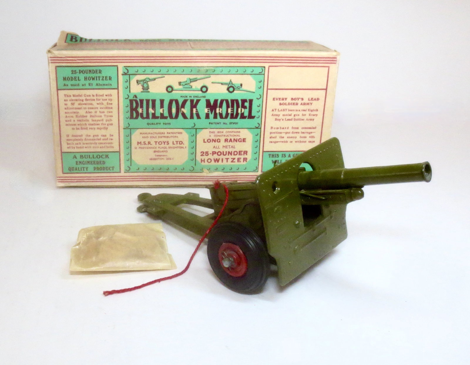 Bullock Model 25 Pounder Howitzer: Near mint condition, with packet of wooden "shells". Box in fair condition (loose and missing inner tabs).