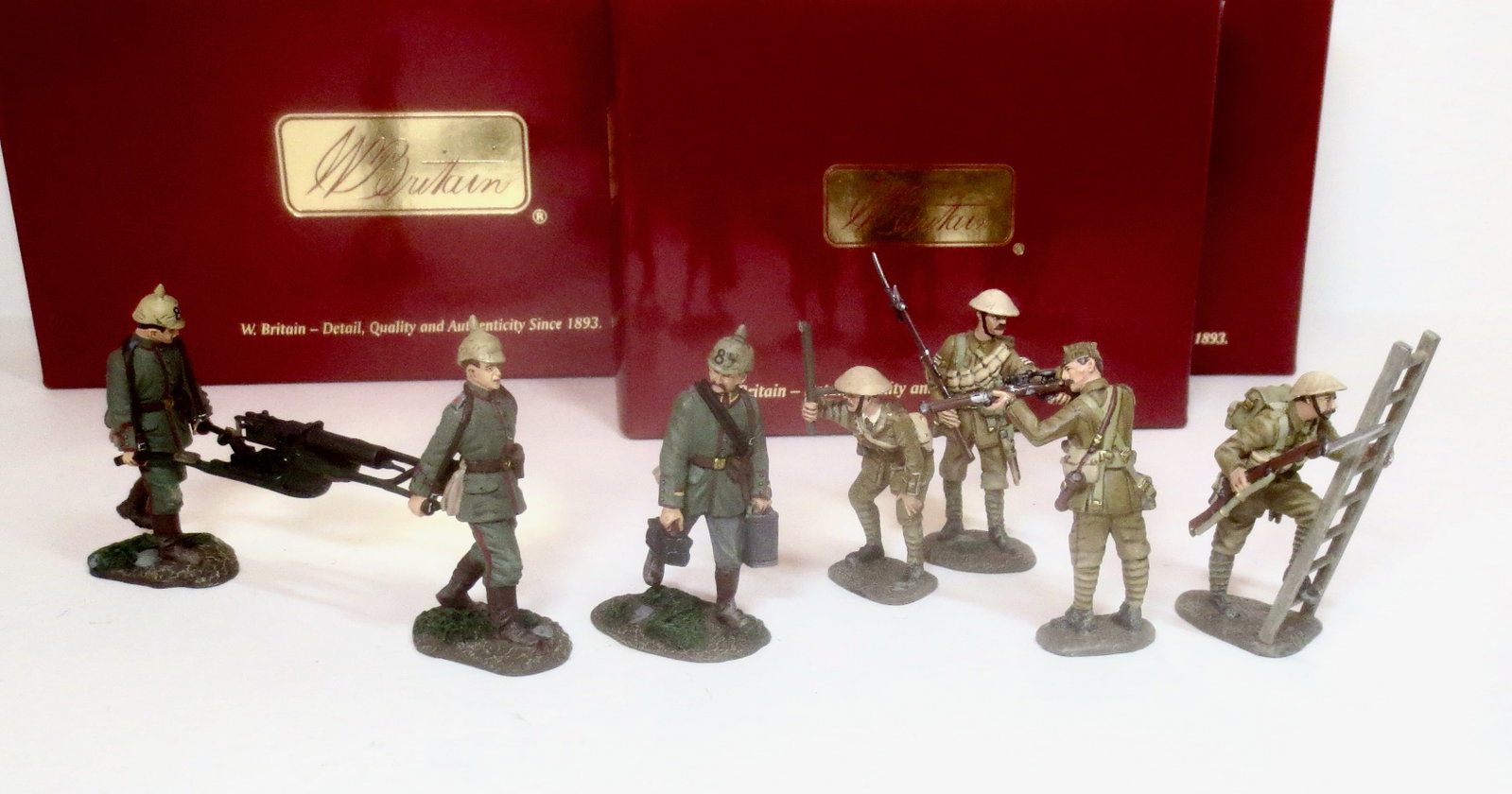 Britains World War I Sets: British Infantry Sniper #23034, British Infantry NCO and Private with Ladder #23026, and German 84th Infantry Machine Gun #17808. 9 pieces. Mint condition. Boxes excellent.