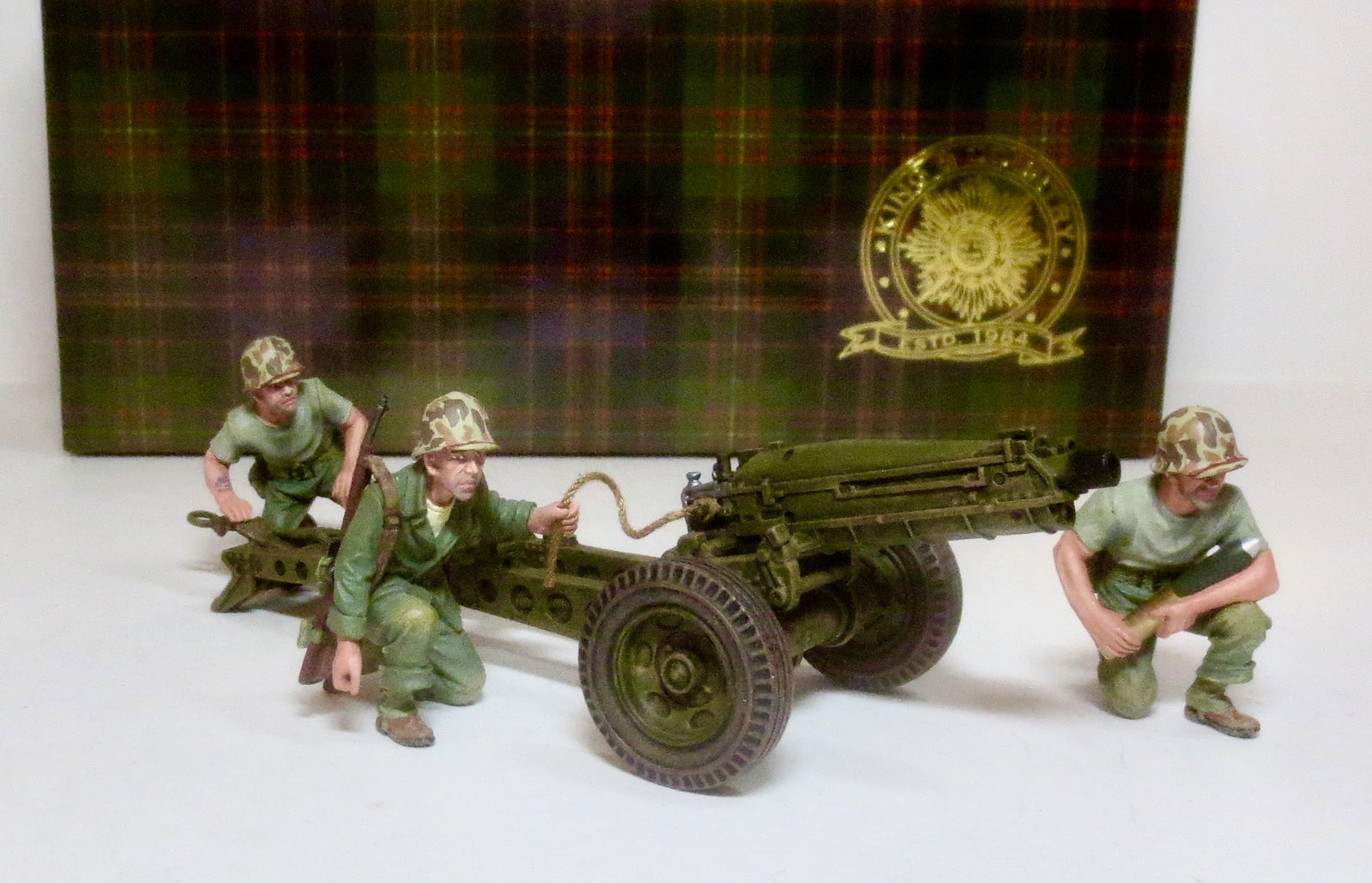 King & Country #USMC041 75mm Pack Howitzer: and three man crew. Originally designed in the 1920?s to meet a demand for a howitzer that could be moved across difficult terrain, the gun and carriage could be broken down and moved by pack animals.