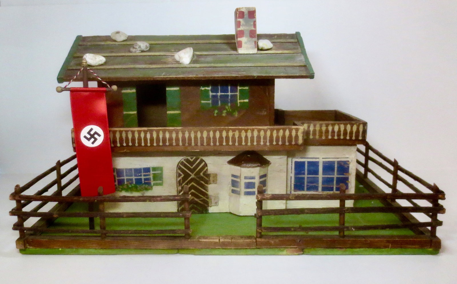 Vintage WWII "Eagles Nest" Wooden Chalet: WW2 German Chalet with Nazi Banner on pole in yard, surrounded by split rail fence. Unidentified vintage maker (possibly Hausser). Measures 19" long, by 9" tall and 14" deep. 4 pieces total including;